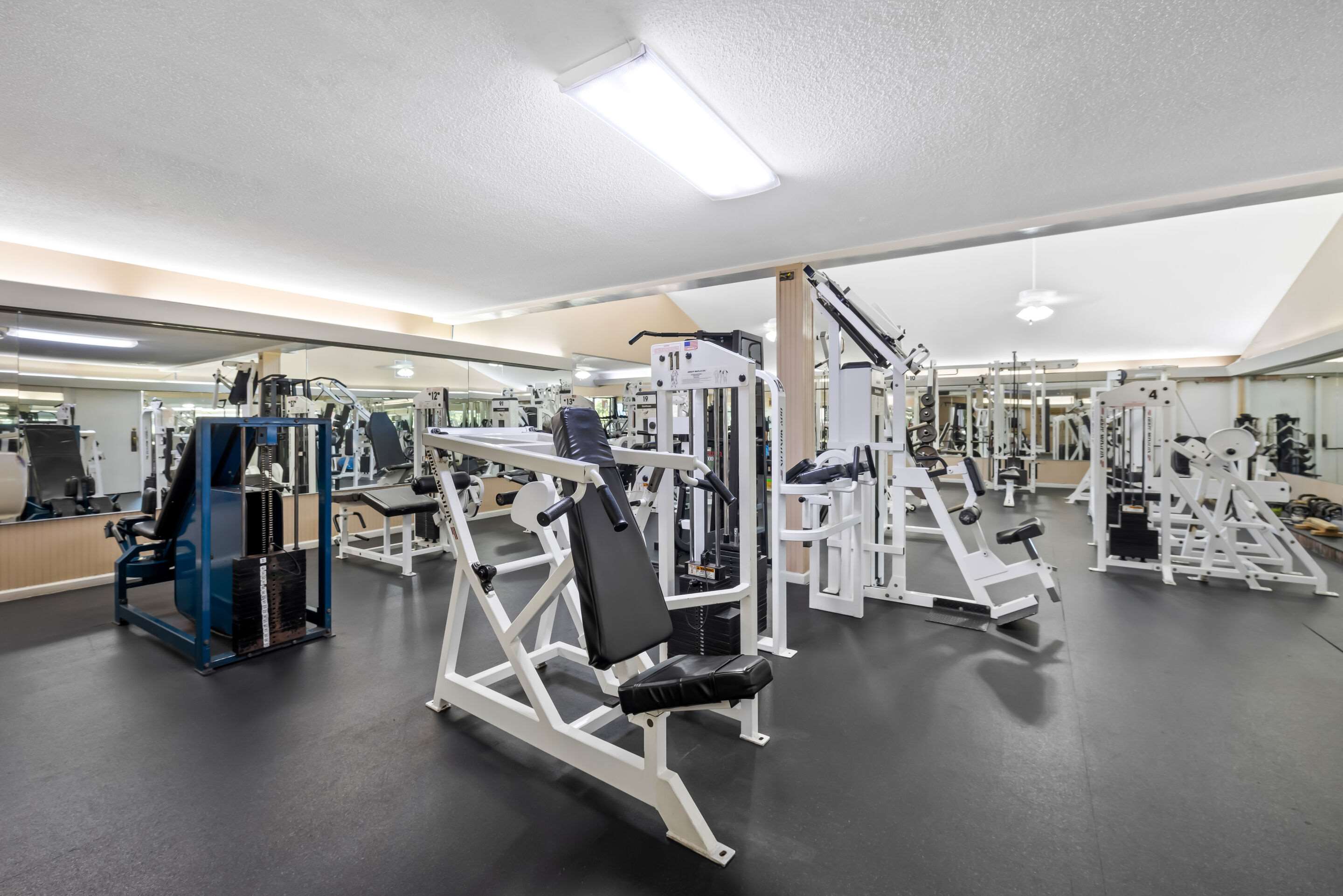 Exercise room with cardio equipment and weights | Quality Inn Morgan City