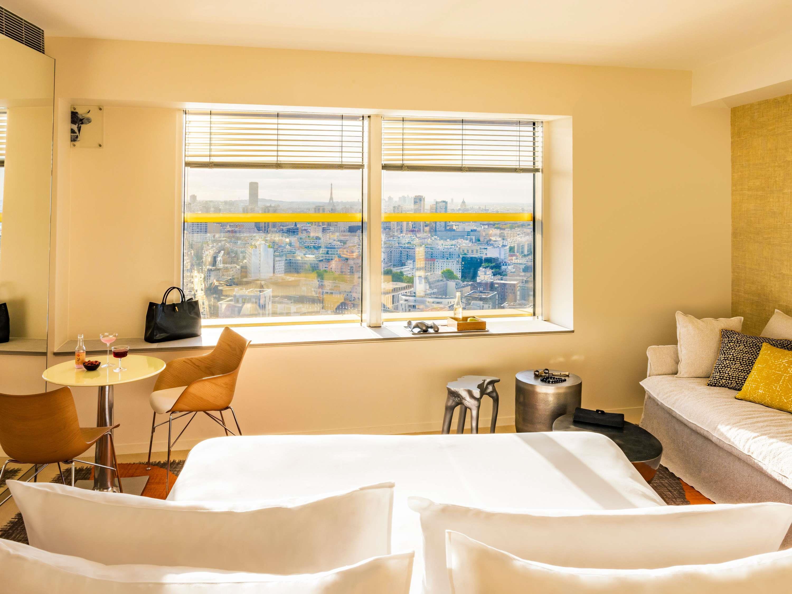 Too Hotel Paris - MGallery Room Type - EIFFEL TOWER JUNIOR SUITE Bathrm with view of Paris at sunset 1 king bed
