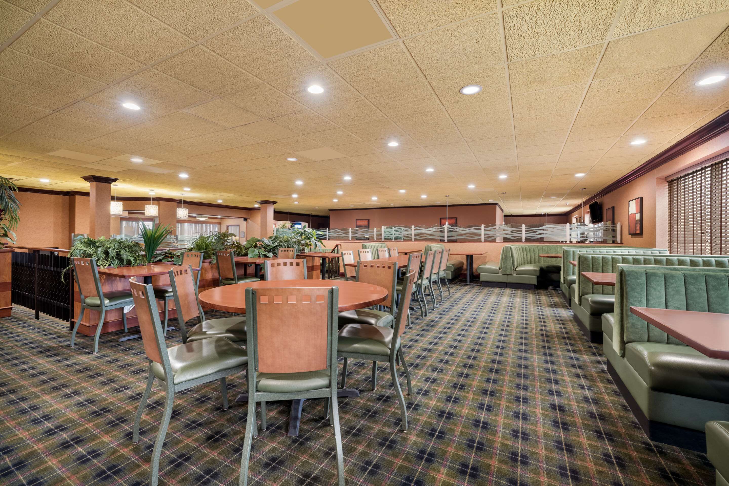 Enjoy breakfast in this seating area | Suburban Studios Syracuse Fairgrounds