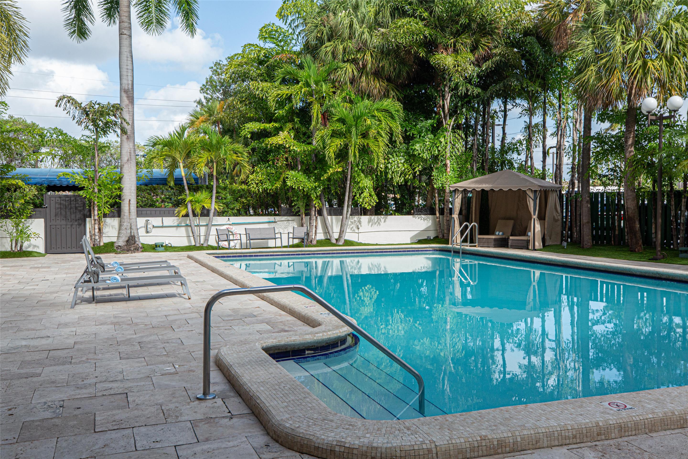 Outdoor Pool and Lounge Chairs | Regency Miami Airport by Sonesta