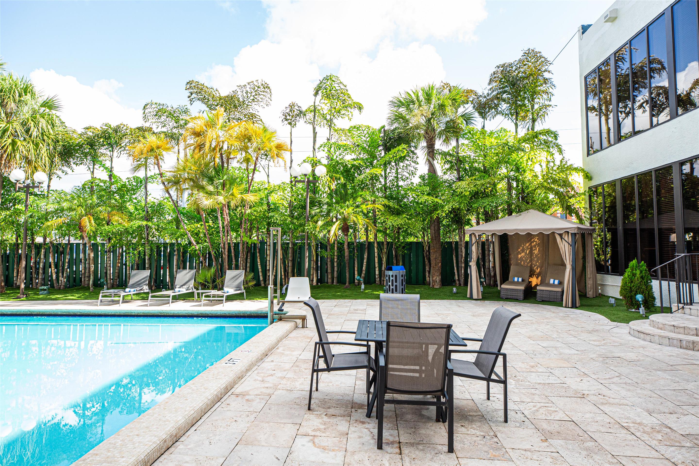 Outdoor Pool and Pool Tables | Regency Miami Airport by Sonesta