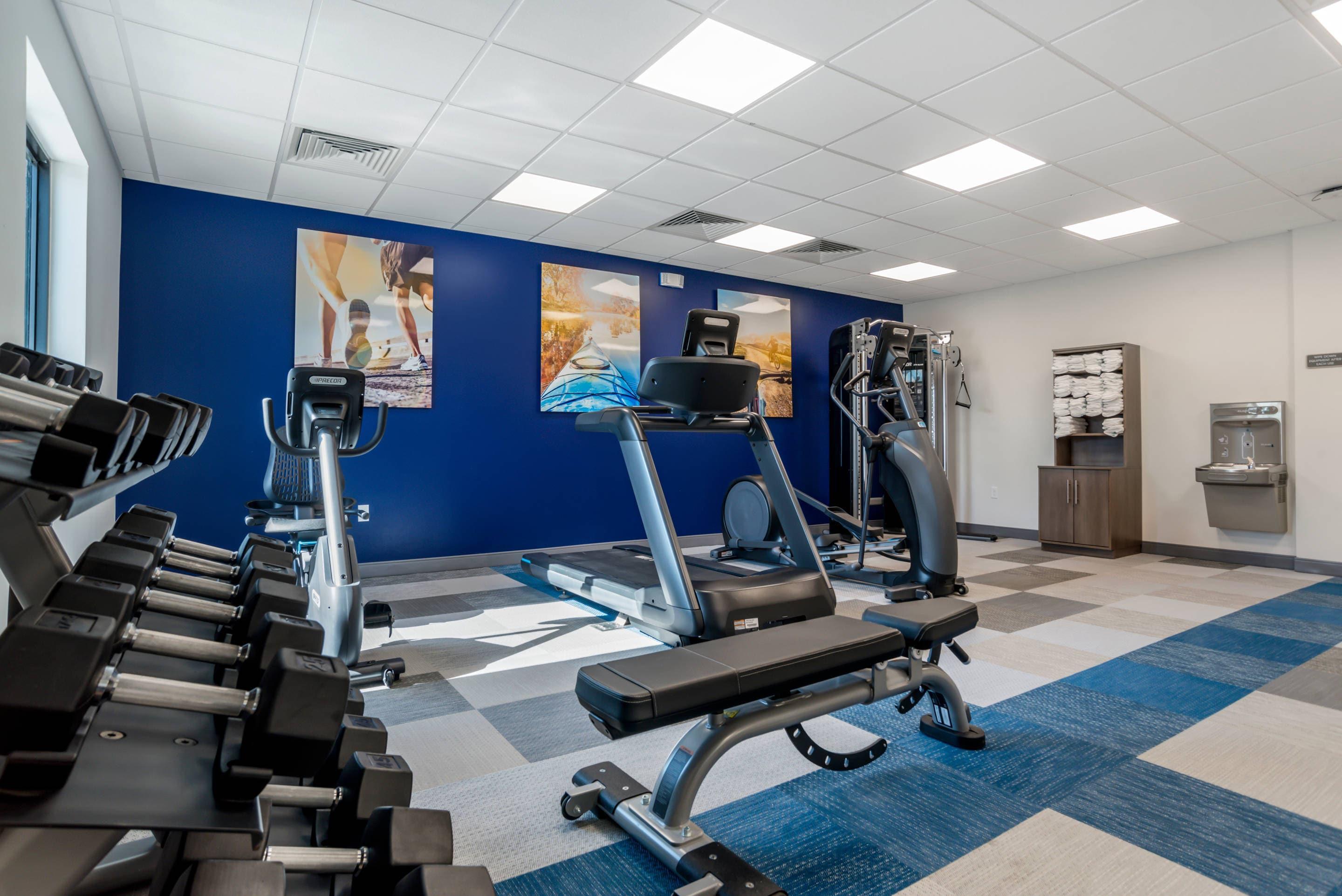 Exercise room with cardio equipment and weights