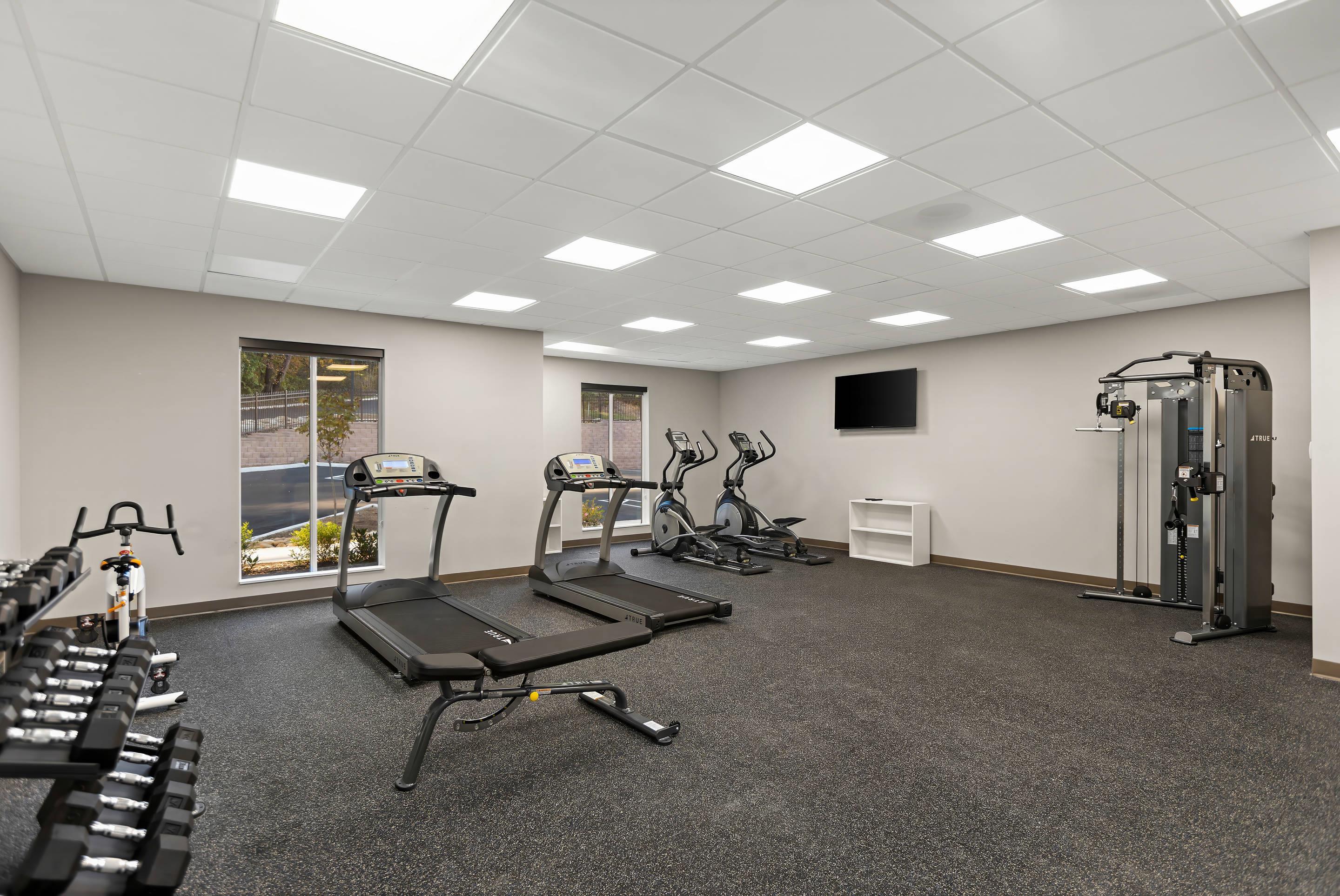 Exercise room with cardio equipment and weights | MainStay Suites Gatlinburg Downtown Area