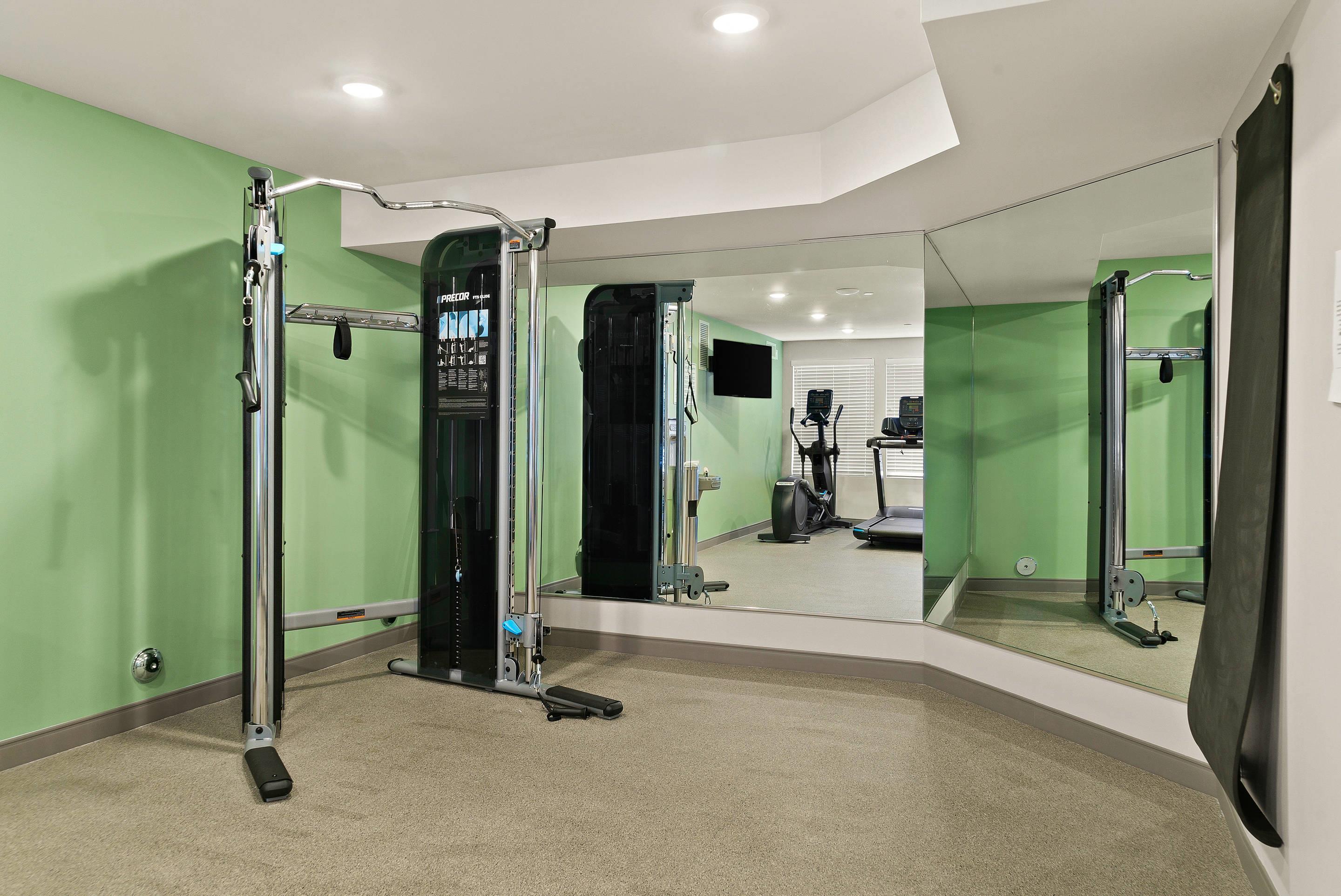 Exercise room | Woodspring Suites East Lansing - University Area