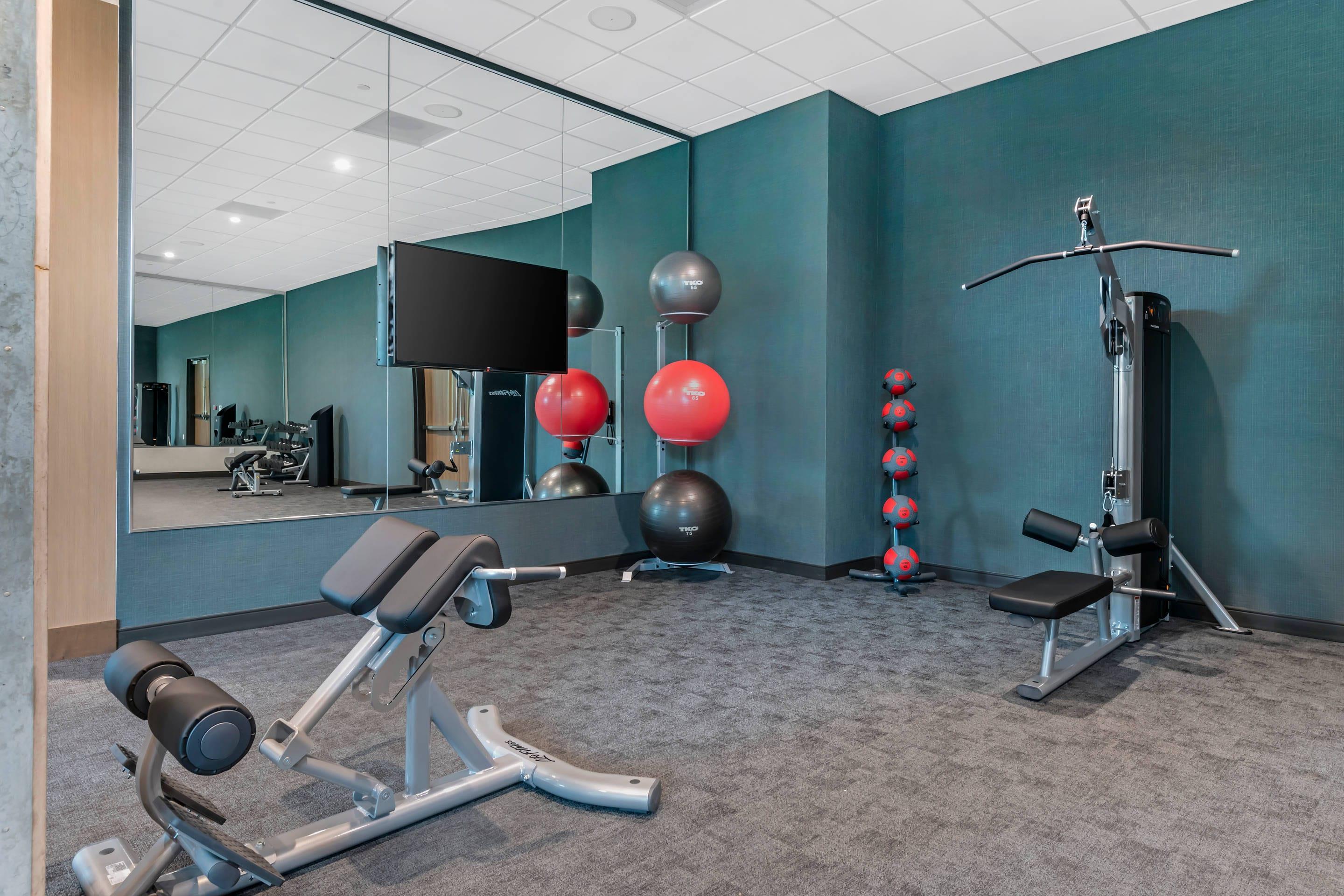 Exercise room with cardio equipment and weights | Cambria Hotel Austin Downtown