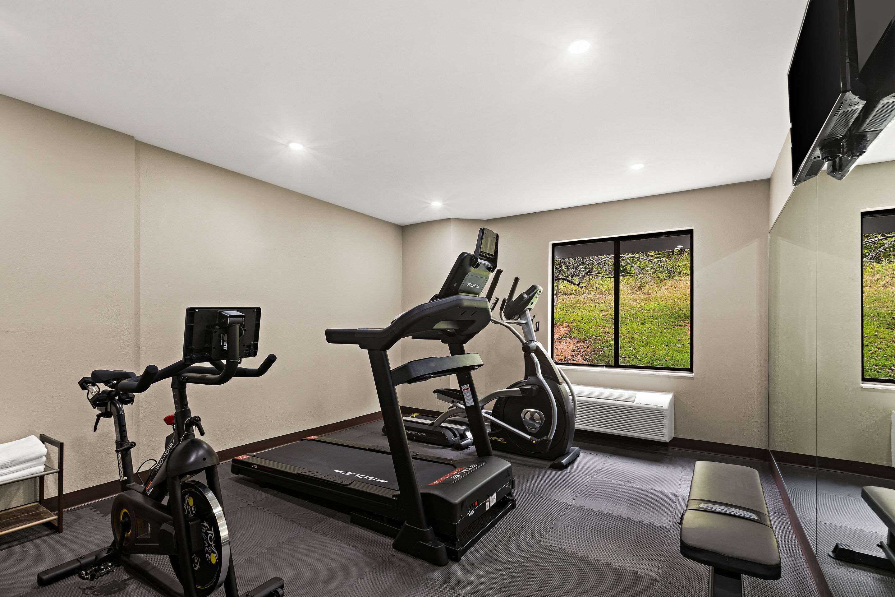Exercise room with cardio equipment | Sleep Inn