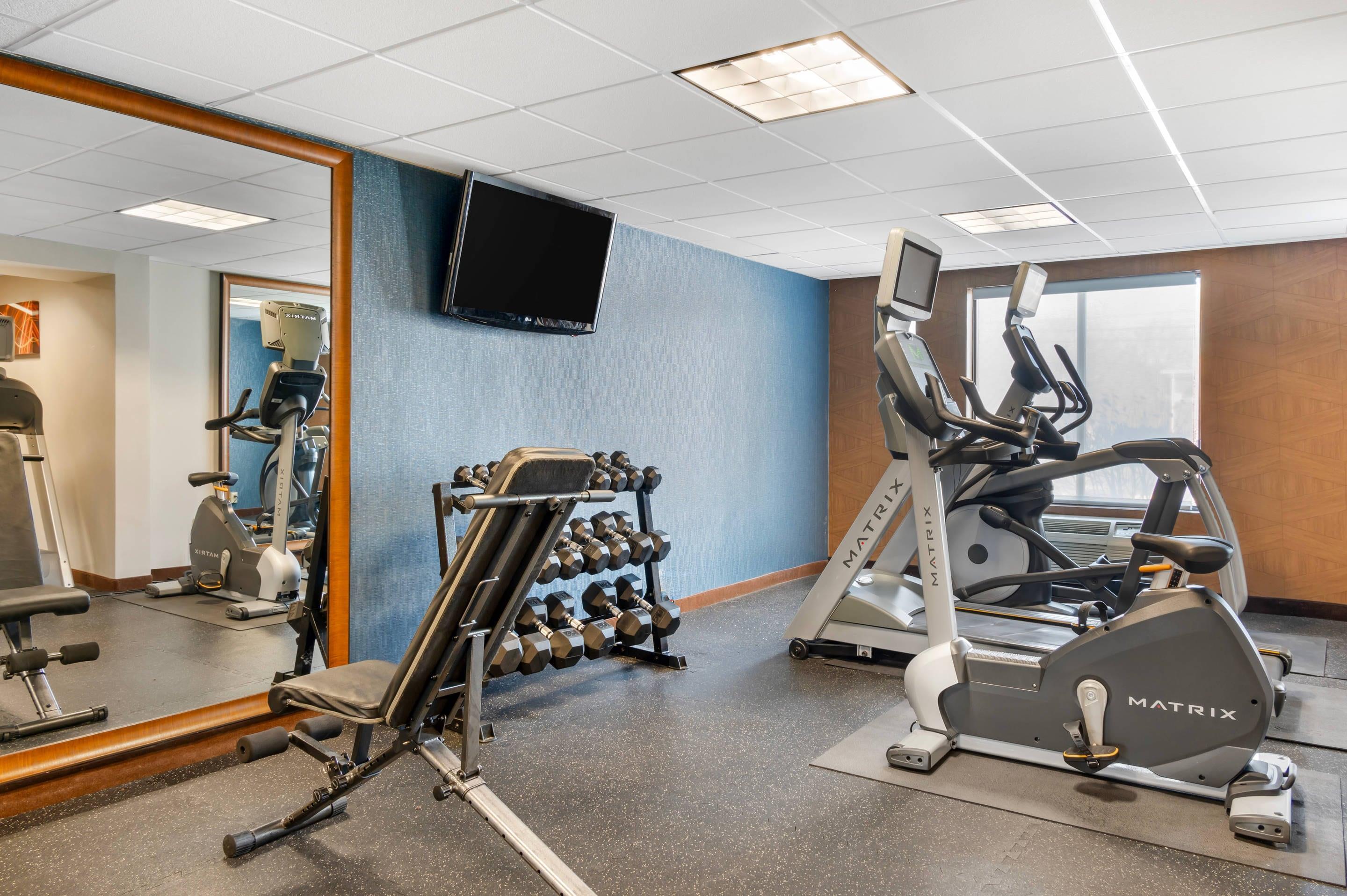Exercise room with cardio equipment and weights