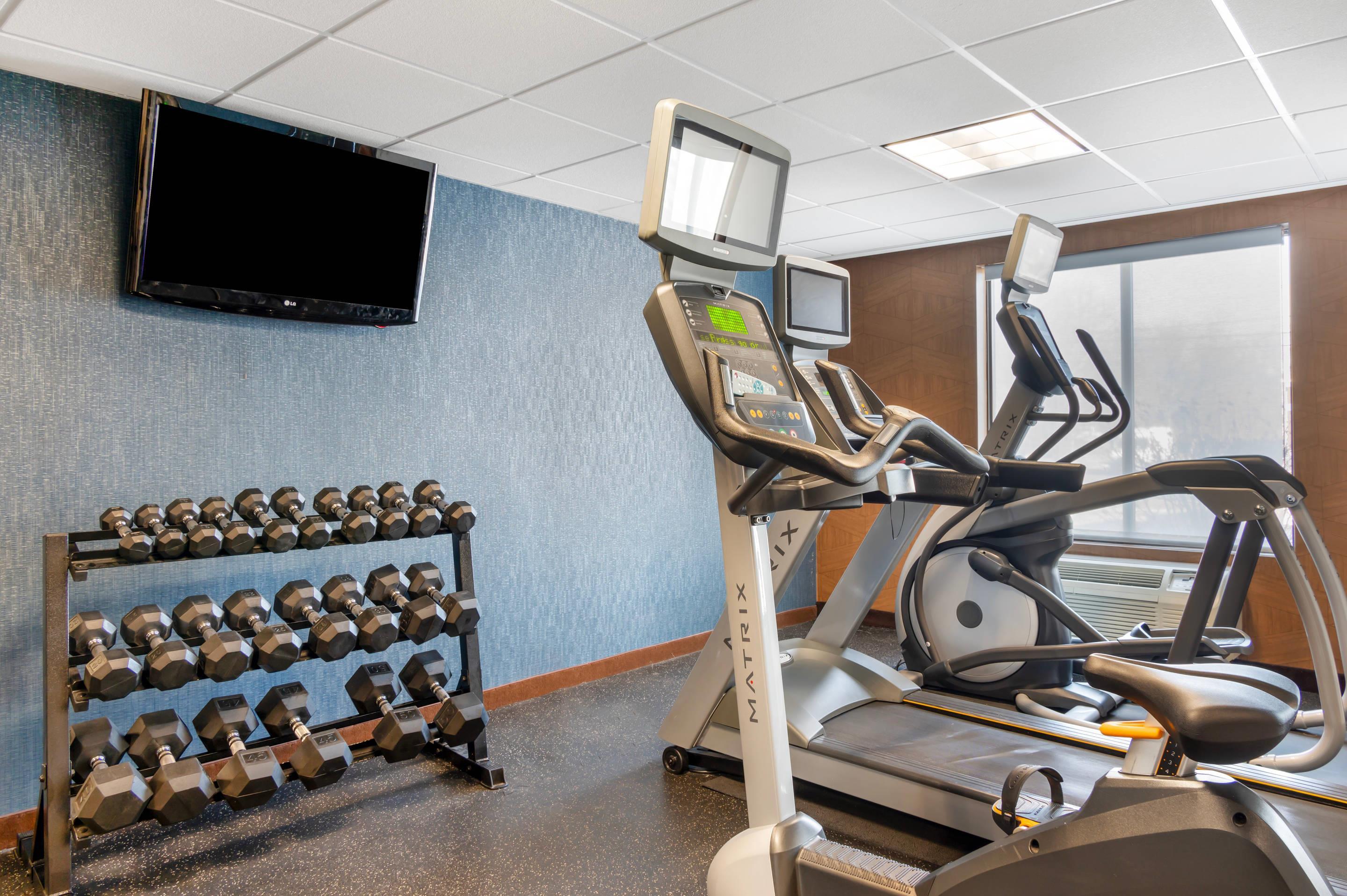 Exercise room with cardio equipment and weights