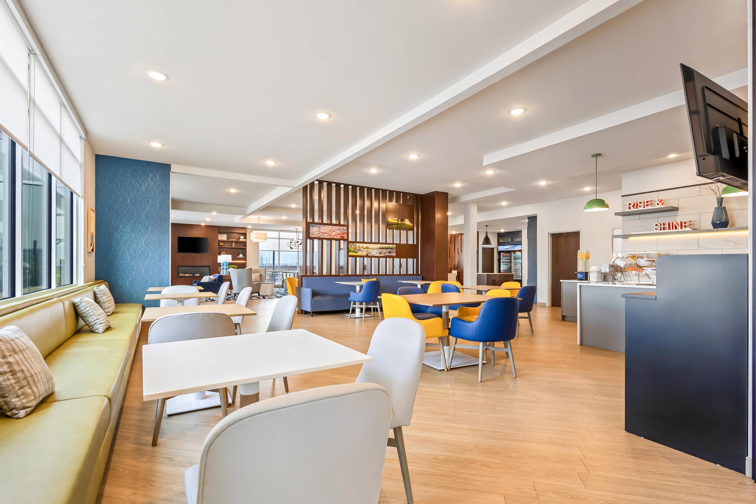 Enjoy breakfast in this seating area | Comfort Inn & Suites at Sanford Sports Complex