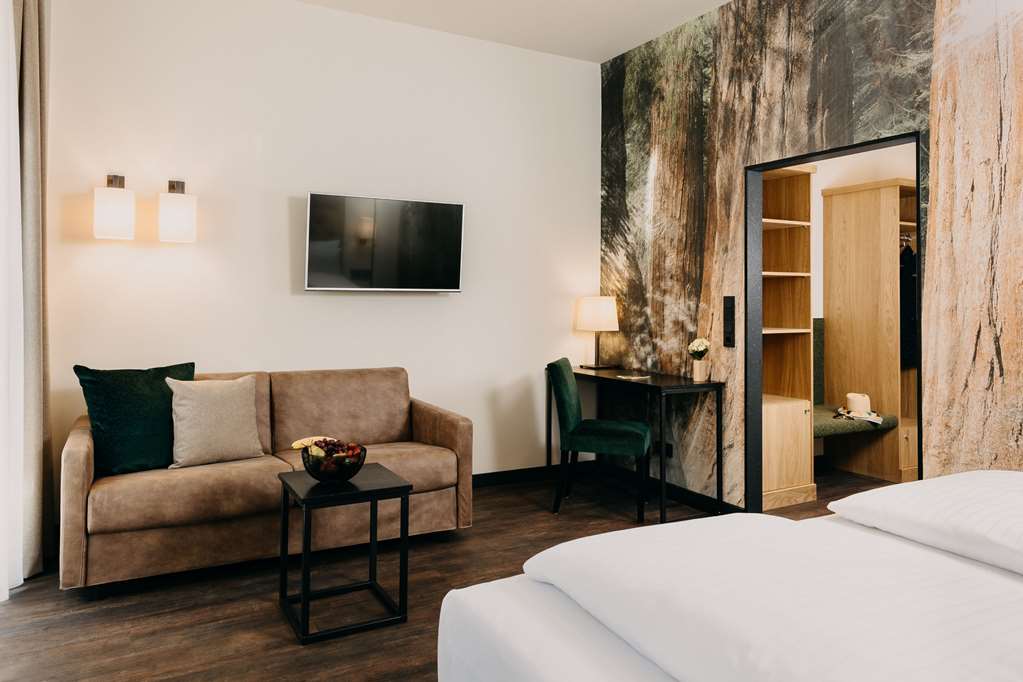 HOTEL FORSTHAUS-guestroom-Guest Room,Bed,Living Area,Architecture,Indoor/Interior,On-Site,Décor detail,Summer,View from room,Exterior View of Building.jpg