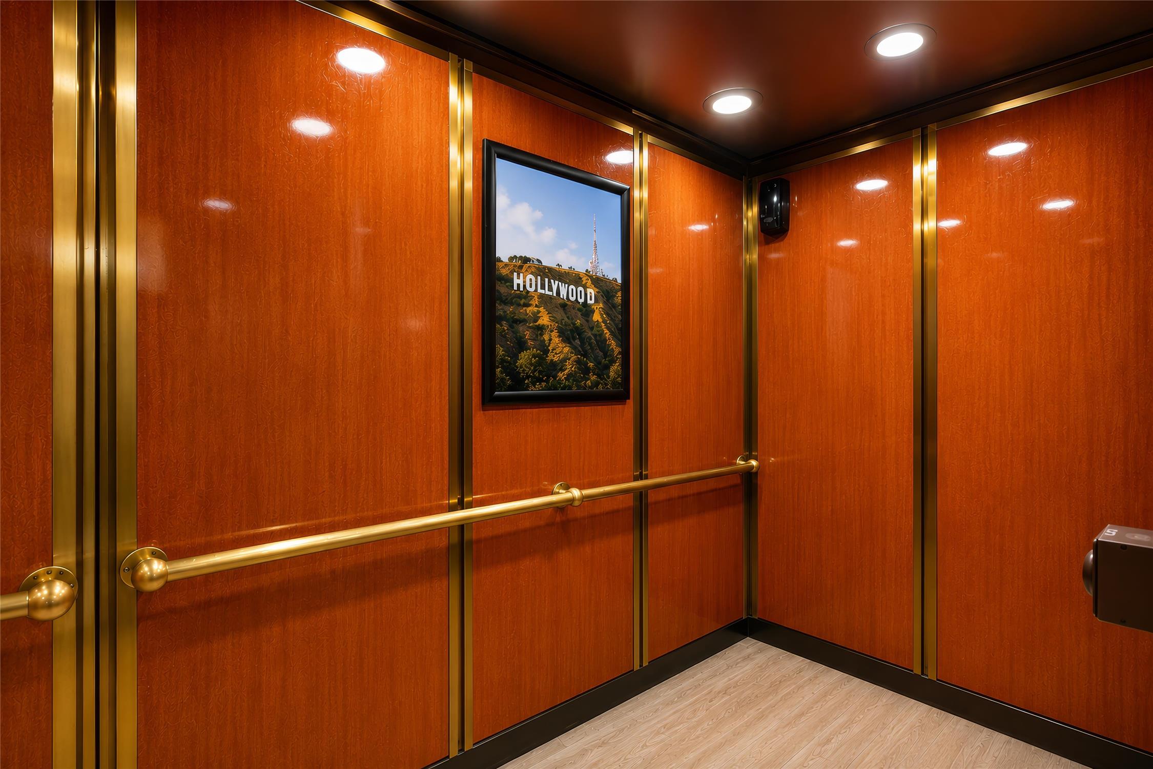 A luxurious elevator interior with wood paneling and gold accents