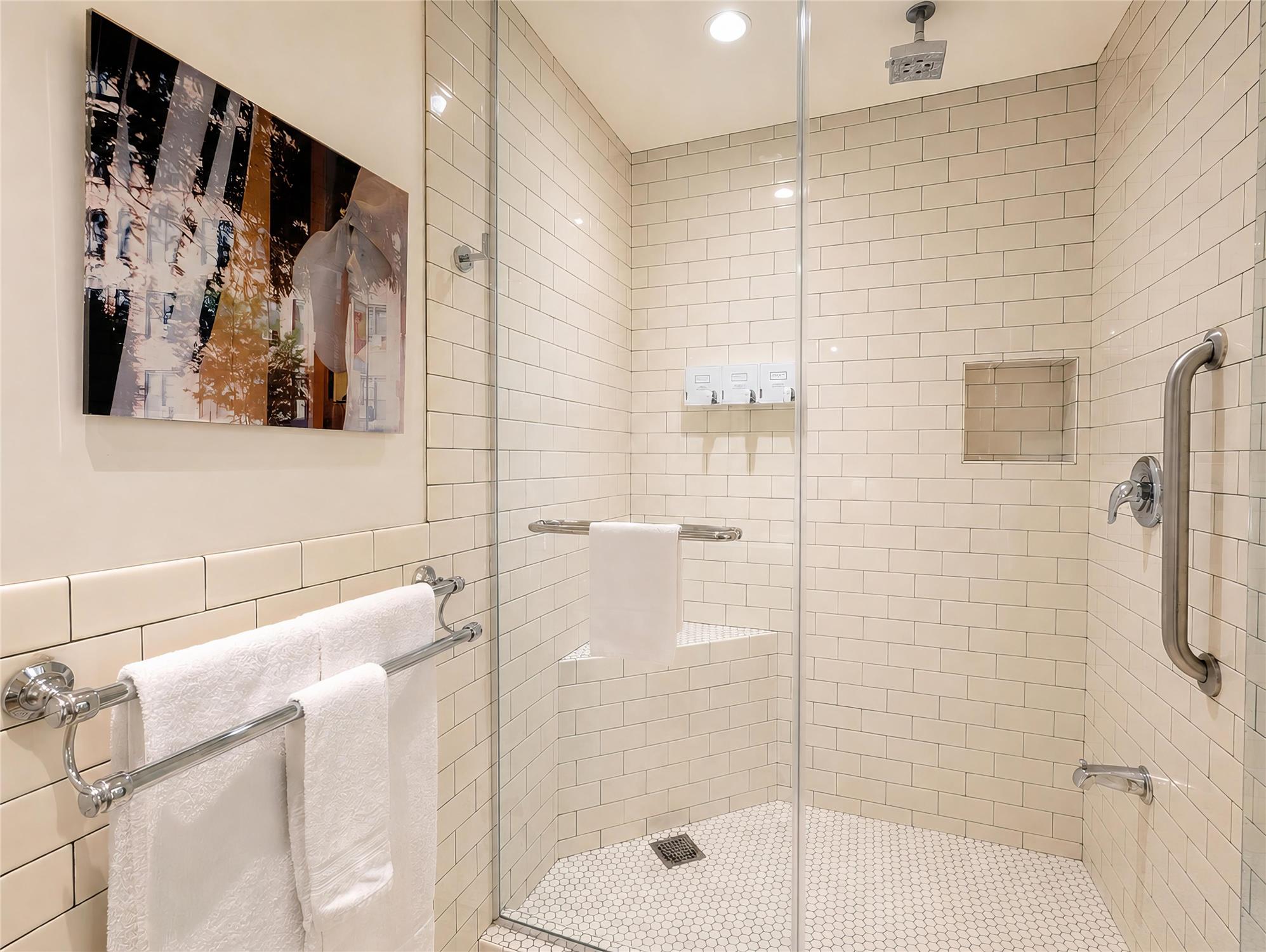 a clean bathroom with a large walk-in shower and modern fixtures