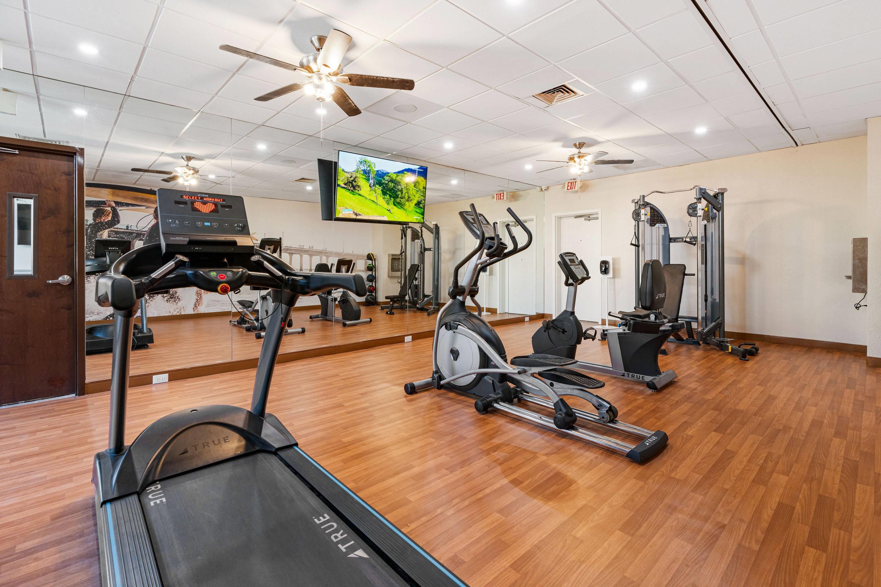 Exercise room with cardio equipment | Beachfront Palms Hotel Galveston