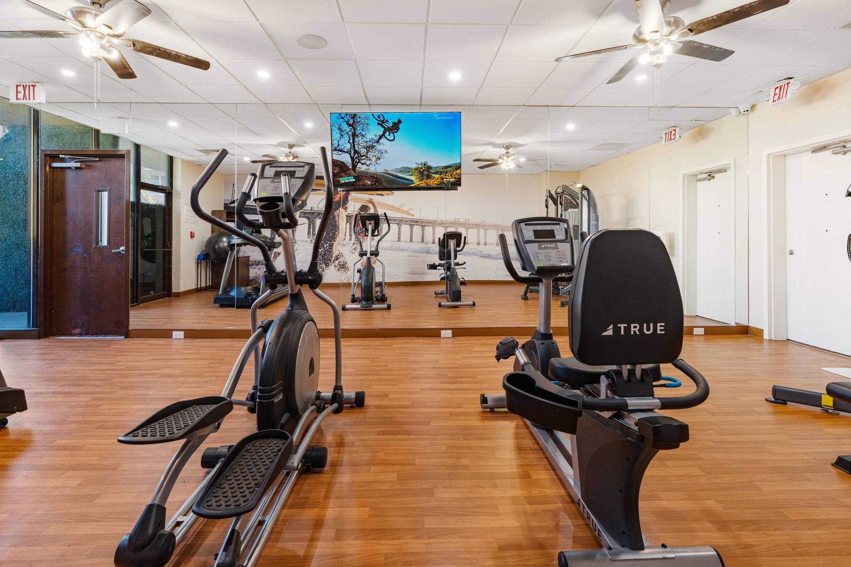 Exercise room with cardio equipment | Beachfront Palms Hotel Galveston