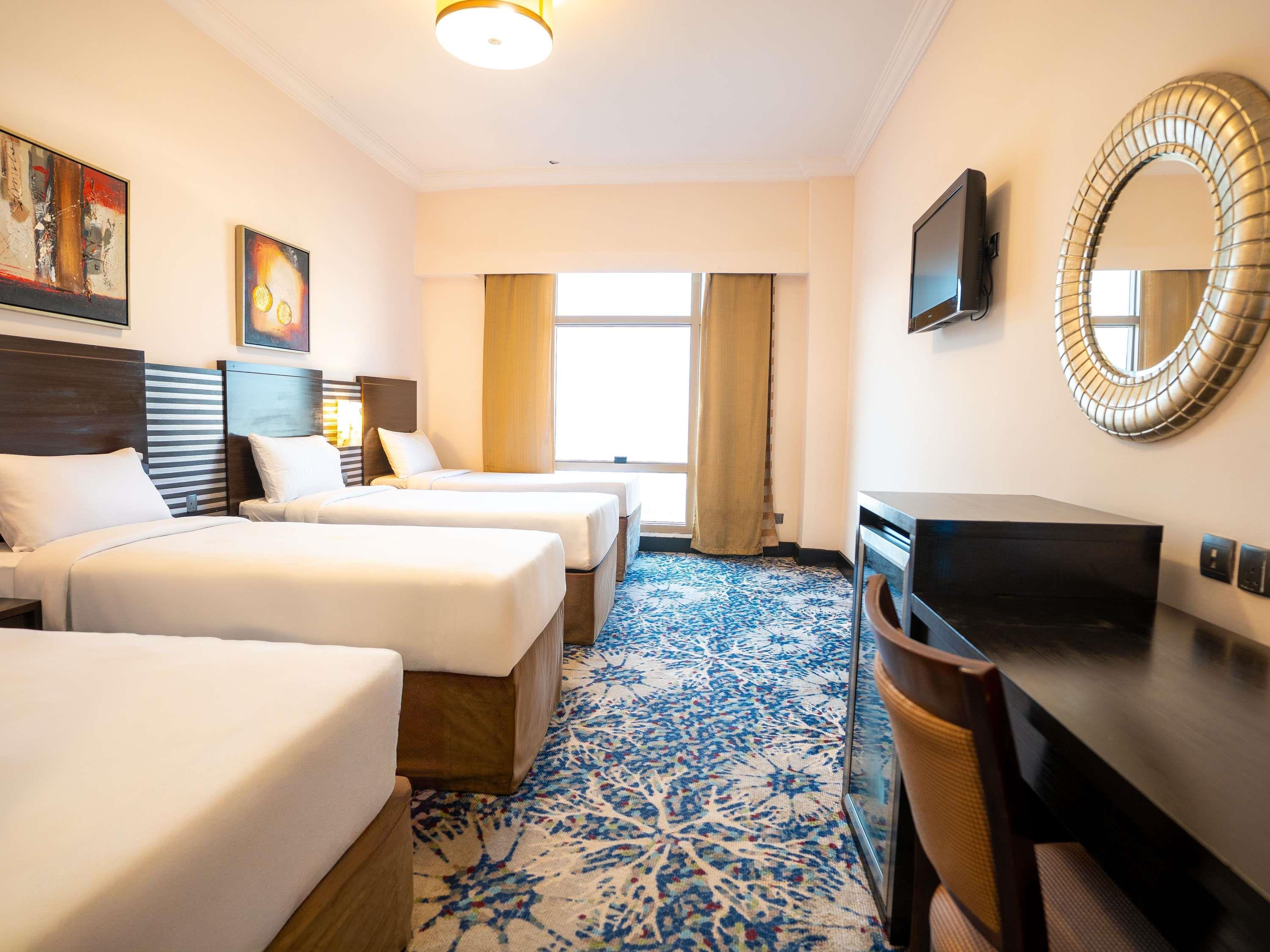 Al Hidayah Towers & Hotel Room Type - Deluxe Quad Room with Four Single Beds Al Hidayah Towers & Hotel Room Type - Deluxe Quad Room with Four Single Beds