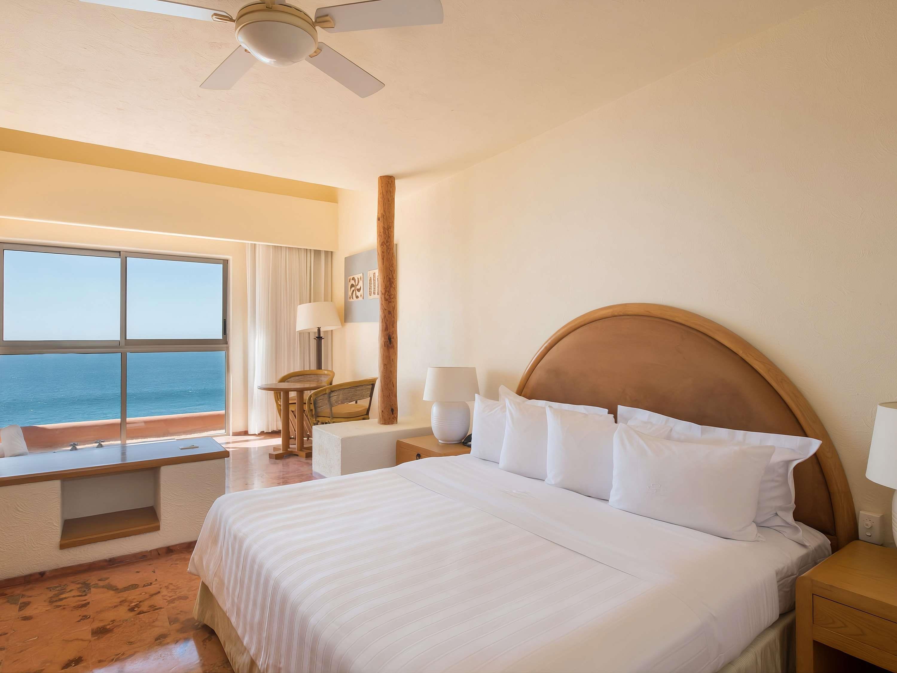 Club Regina Los Cabos Room Type - Studio Room with one king-size bed, jacuzzi, coffee table, and partial ocean view