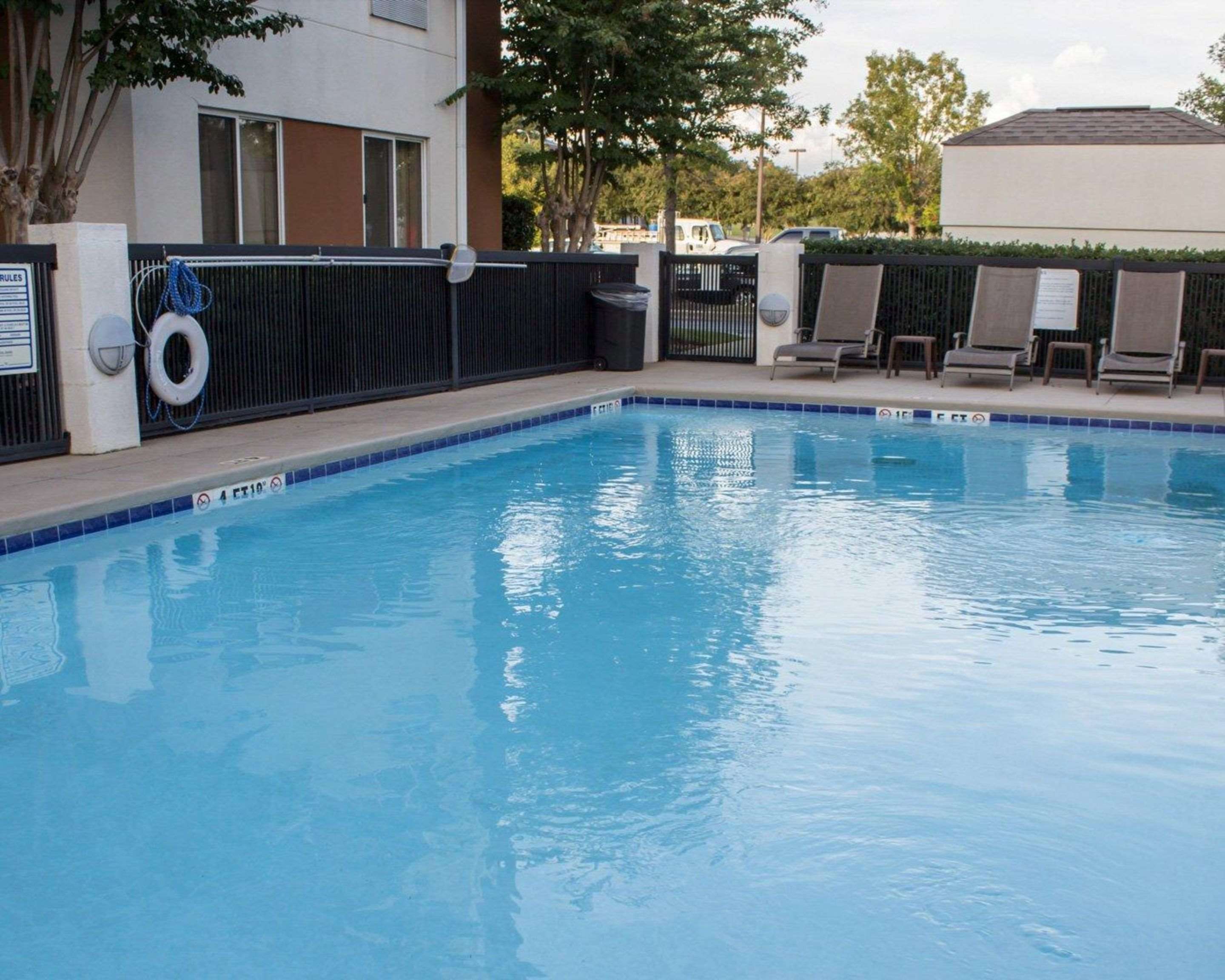 Outdoor pool in garden setting | Sleep Inn Pelham Oak Mountain
