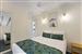 Guest room with one queen bed and two single beds