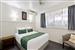 Guest room with one queen bed and one single bed