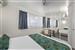 Guest room with one queen bed and one single bed