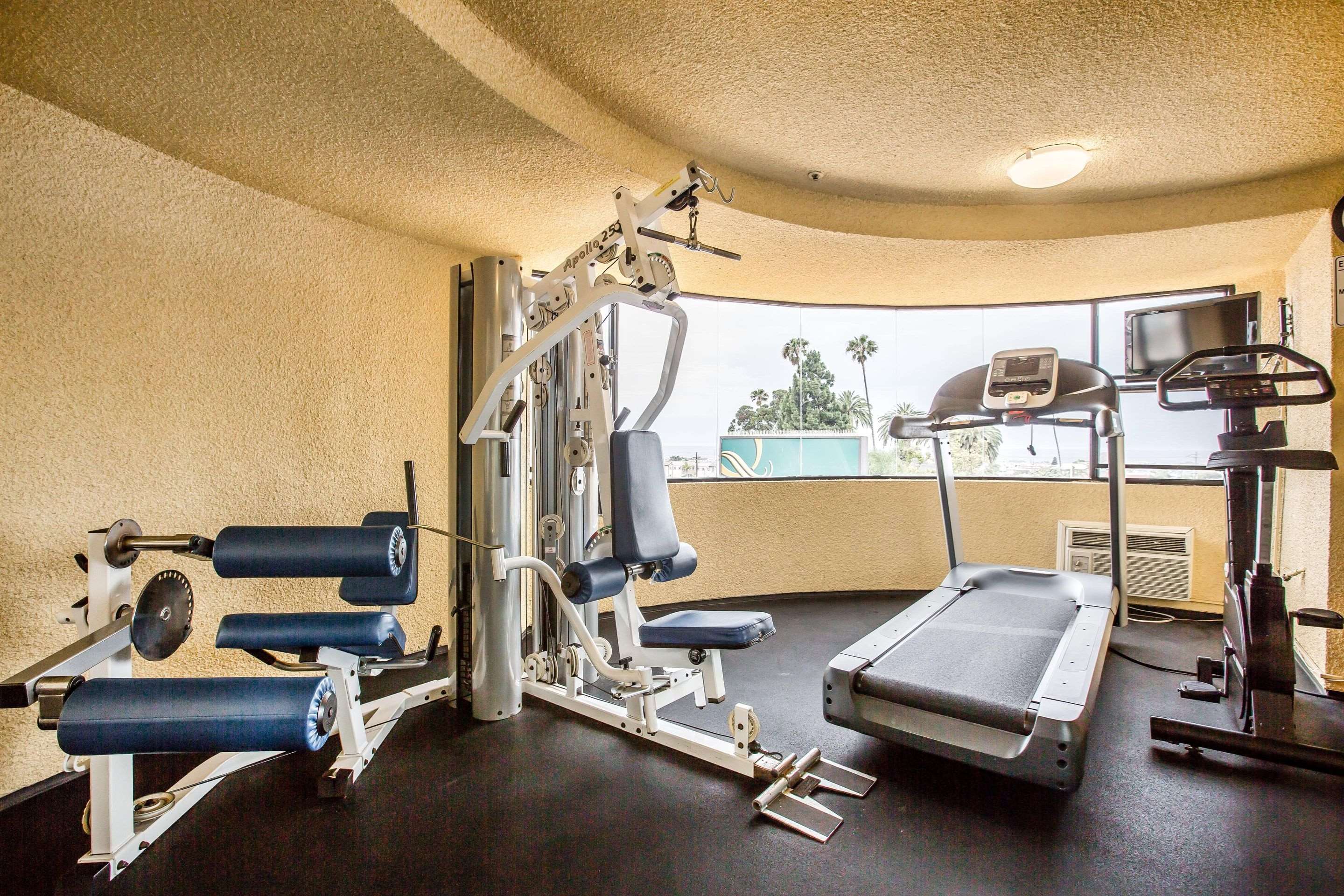 Fitness center with cardio equipment and weights | Quality Inn & Suites Hermosa Beach