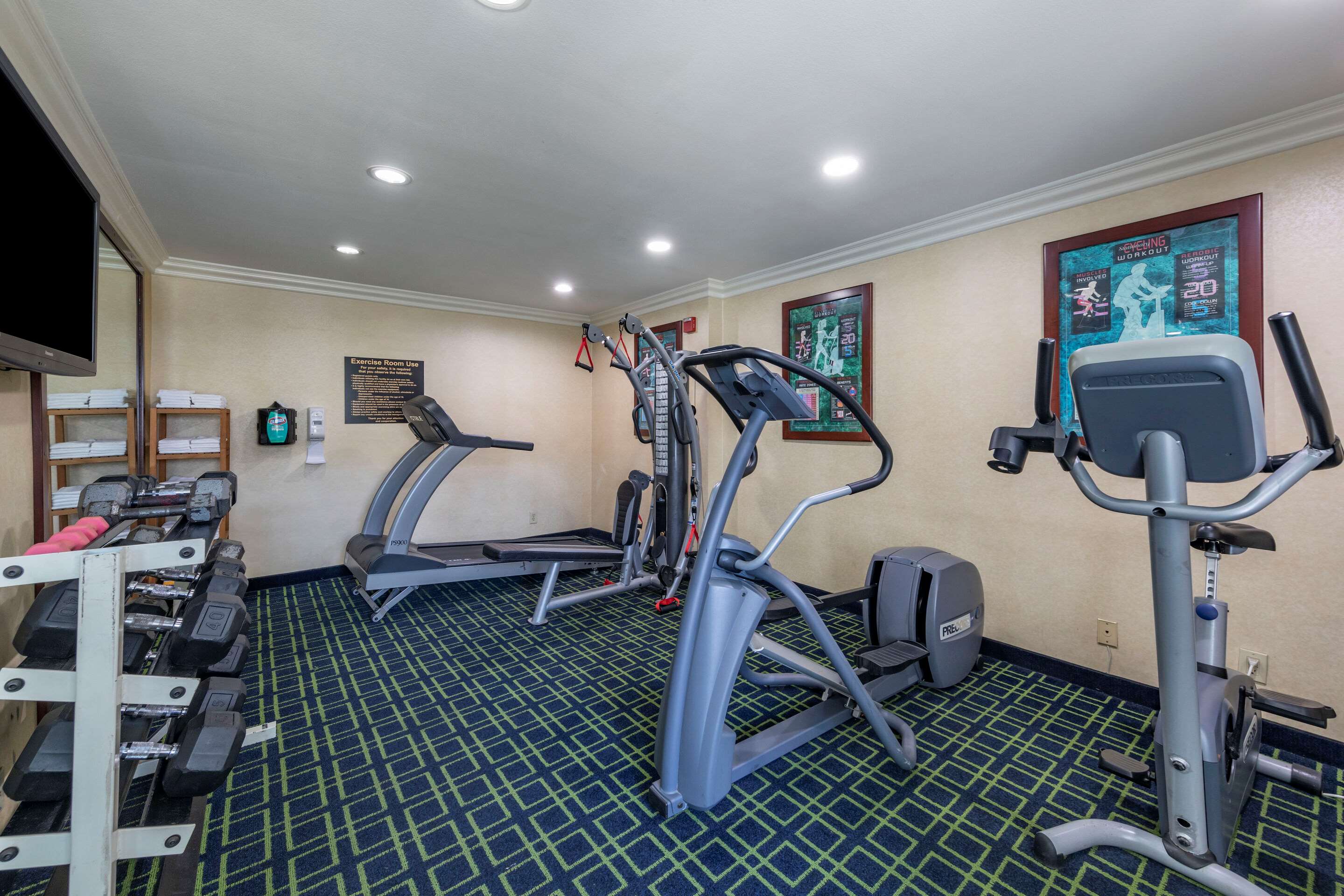 Exercise room with cardio equipment and weights