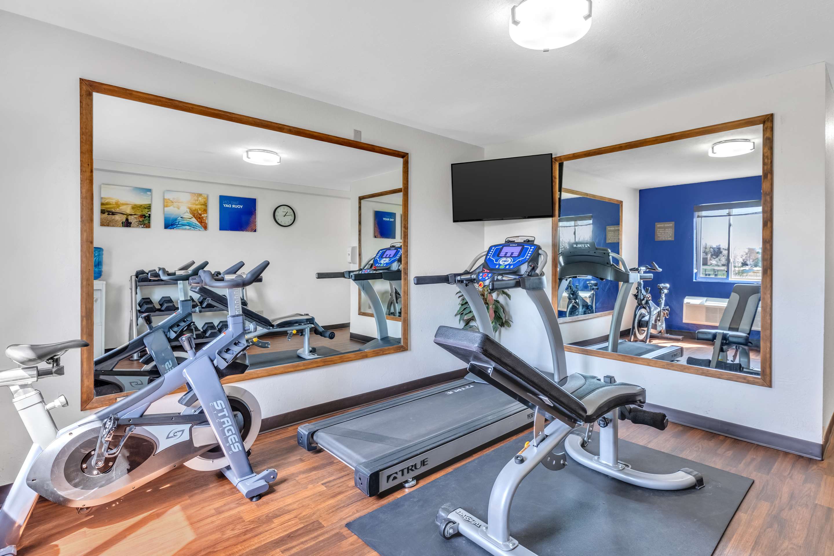 Exercise room with cardio equipment and weights