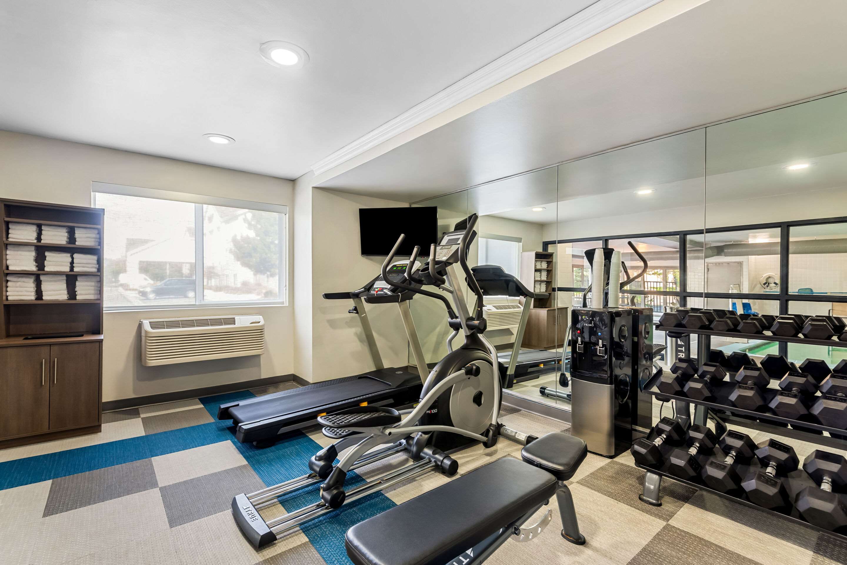 Exercise room with cardio equipment and weights