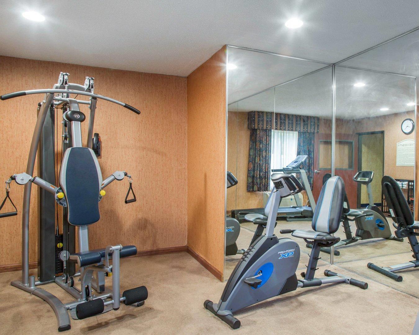 Fitness center with cardio equipment and weights | Quality Inn & Suites