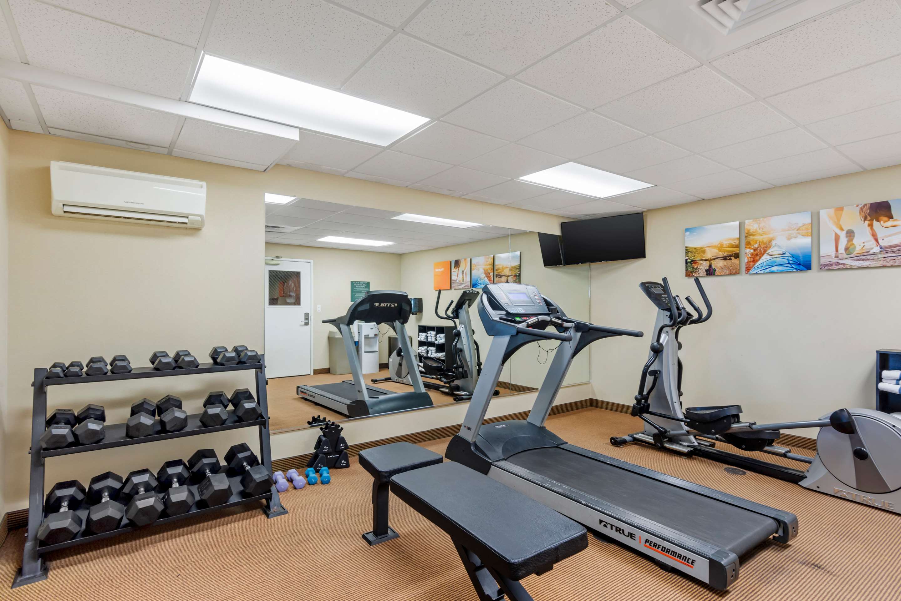 Exercise room with cardio equipment and weights | Comfort Inn & Suites Dover