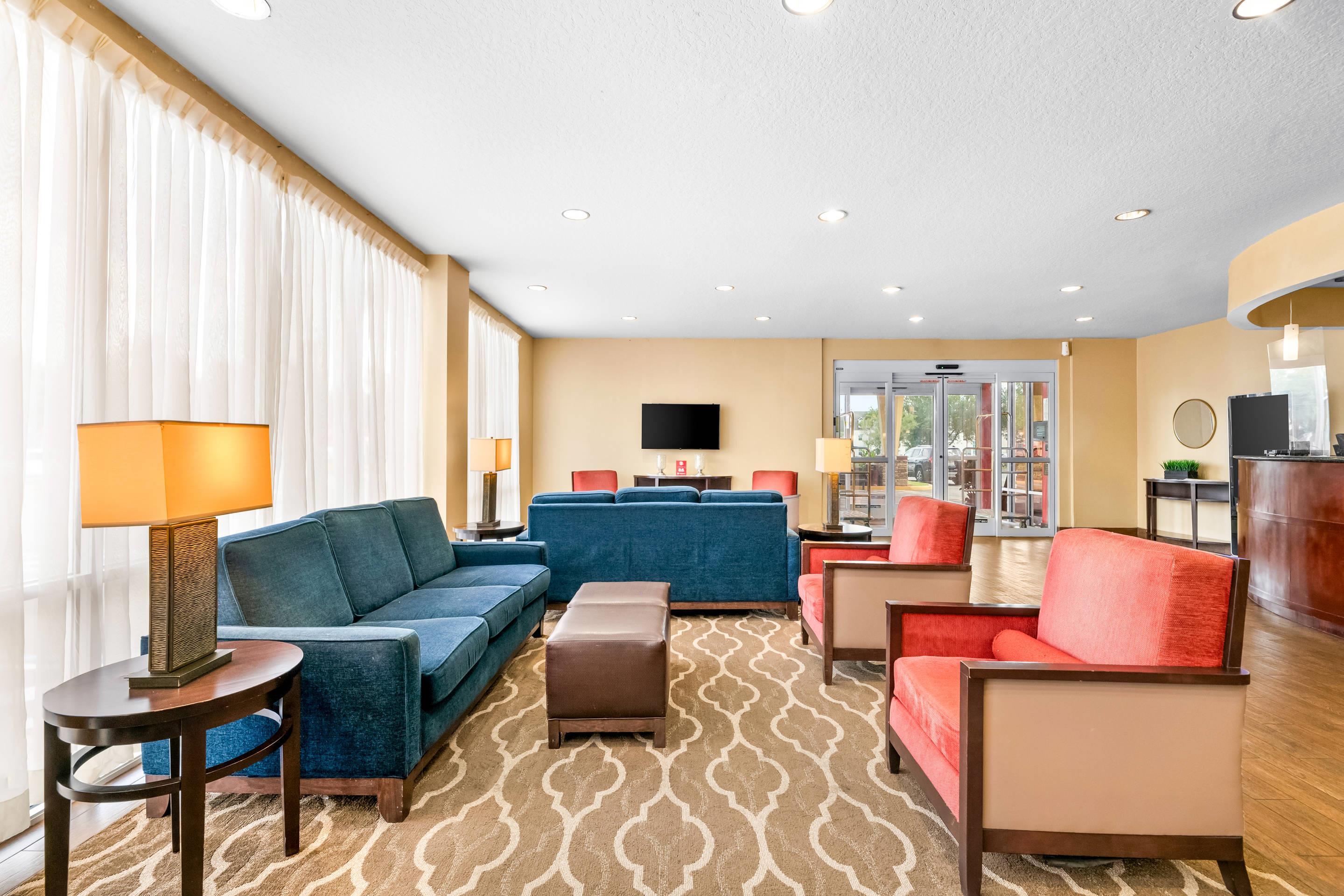 Spacious lobby with sitting area | Comfort Suites Orlando Airport