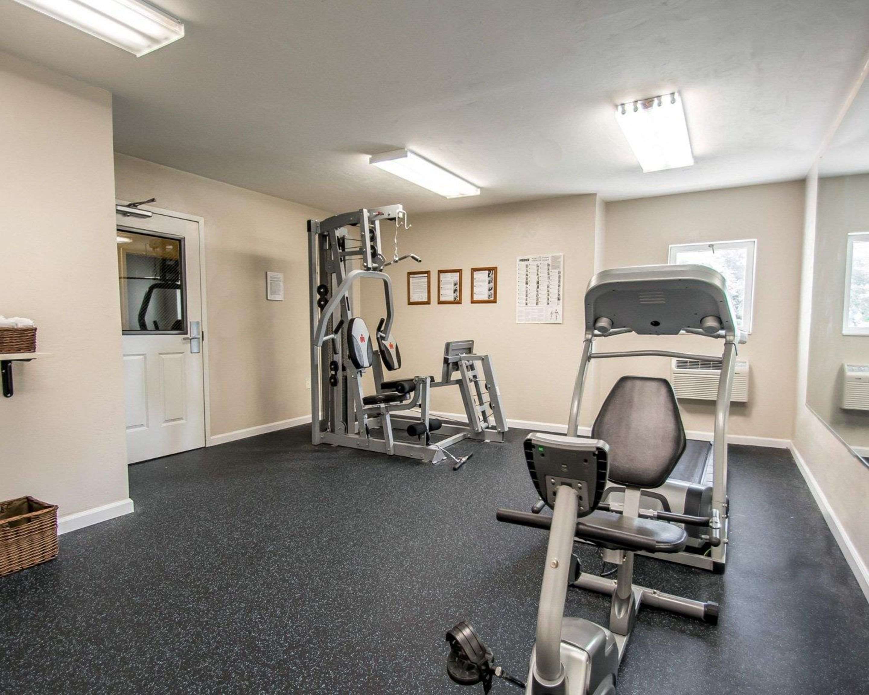 Exercise room with cardio equipment and weights
