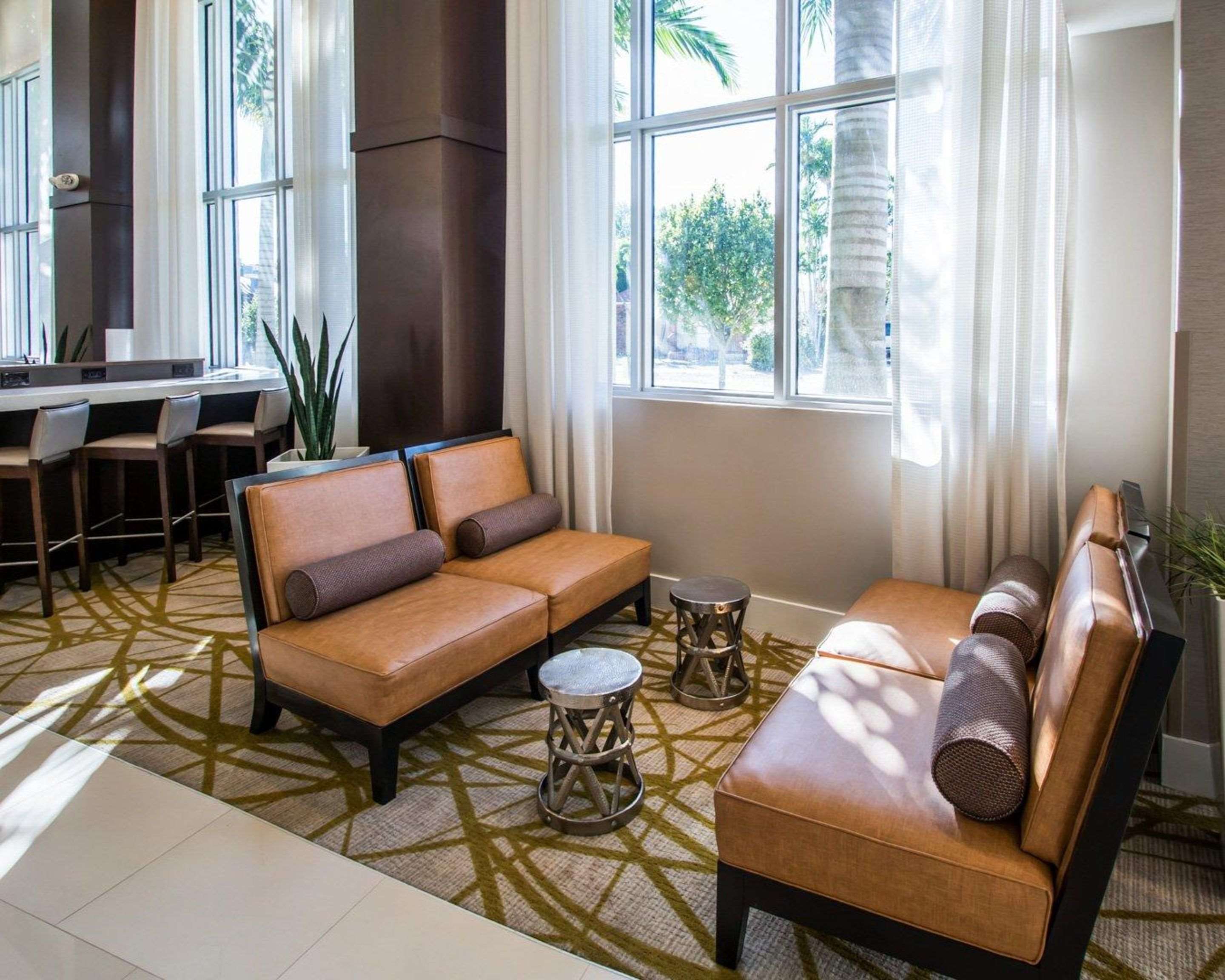 Spacious lobby with sitting area | Comfort Suites Miami Airport North