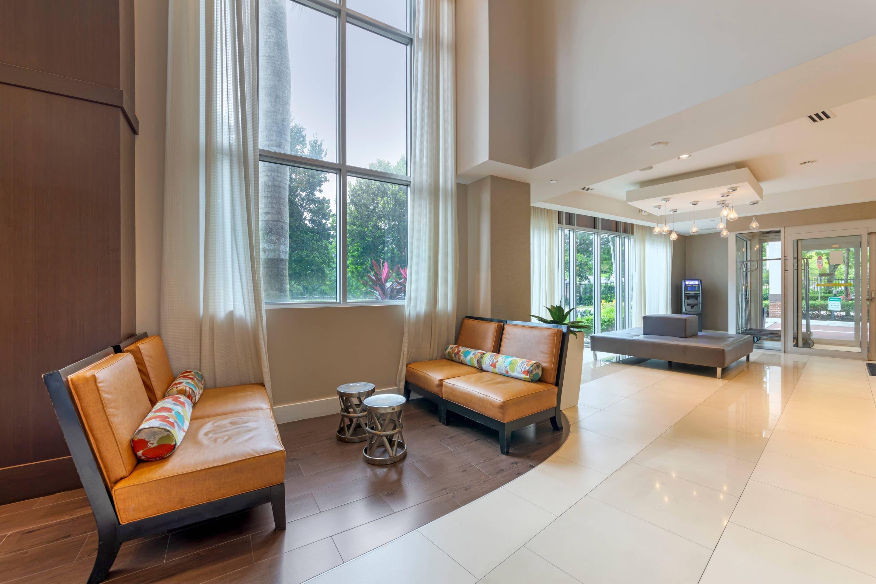 Spacious lobby with sitting area | Comfort Suites Miami Airport North