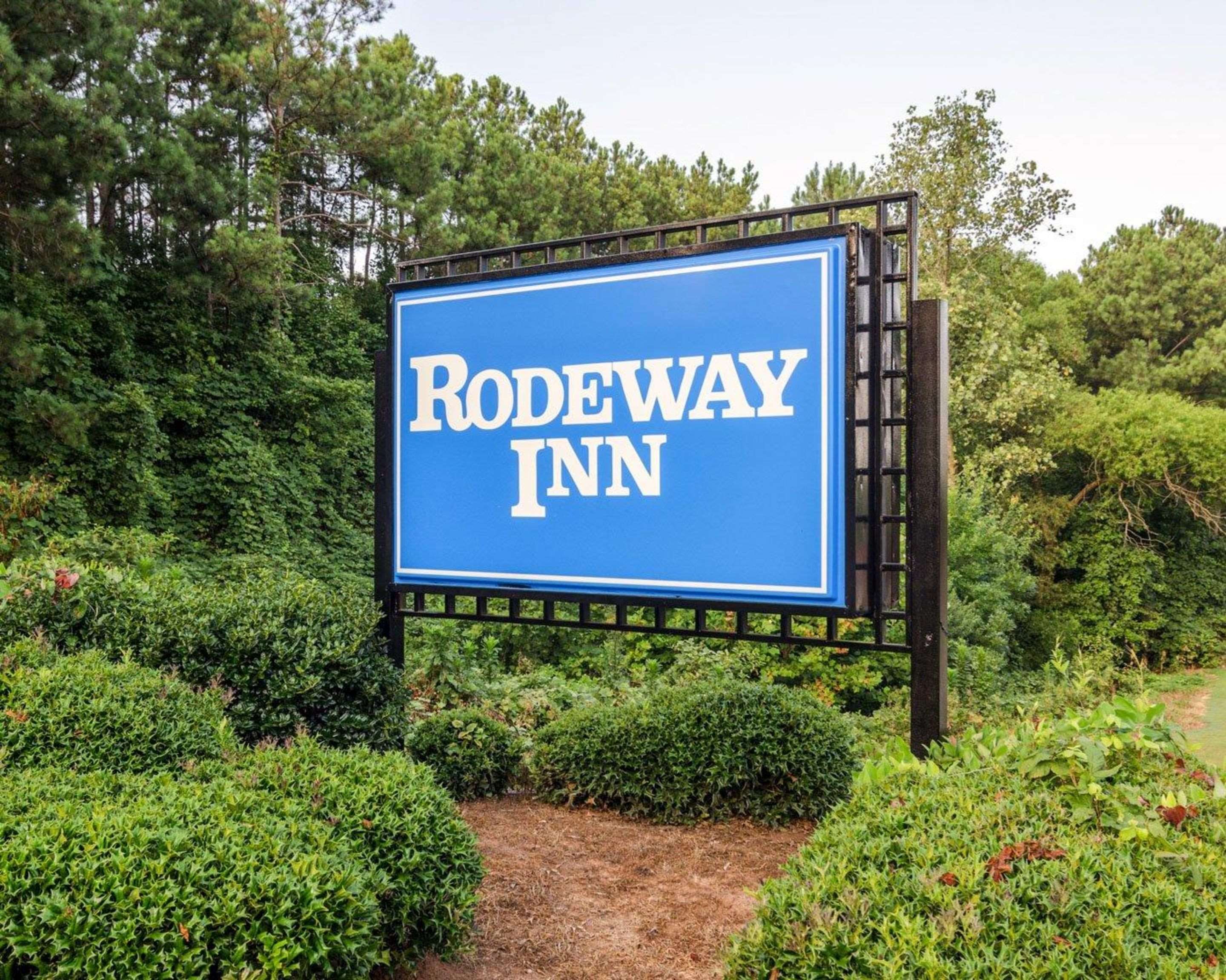Beautiful flowers and shrubs surrounding the hotel | Rodeway Inn Norcross
