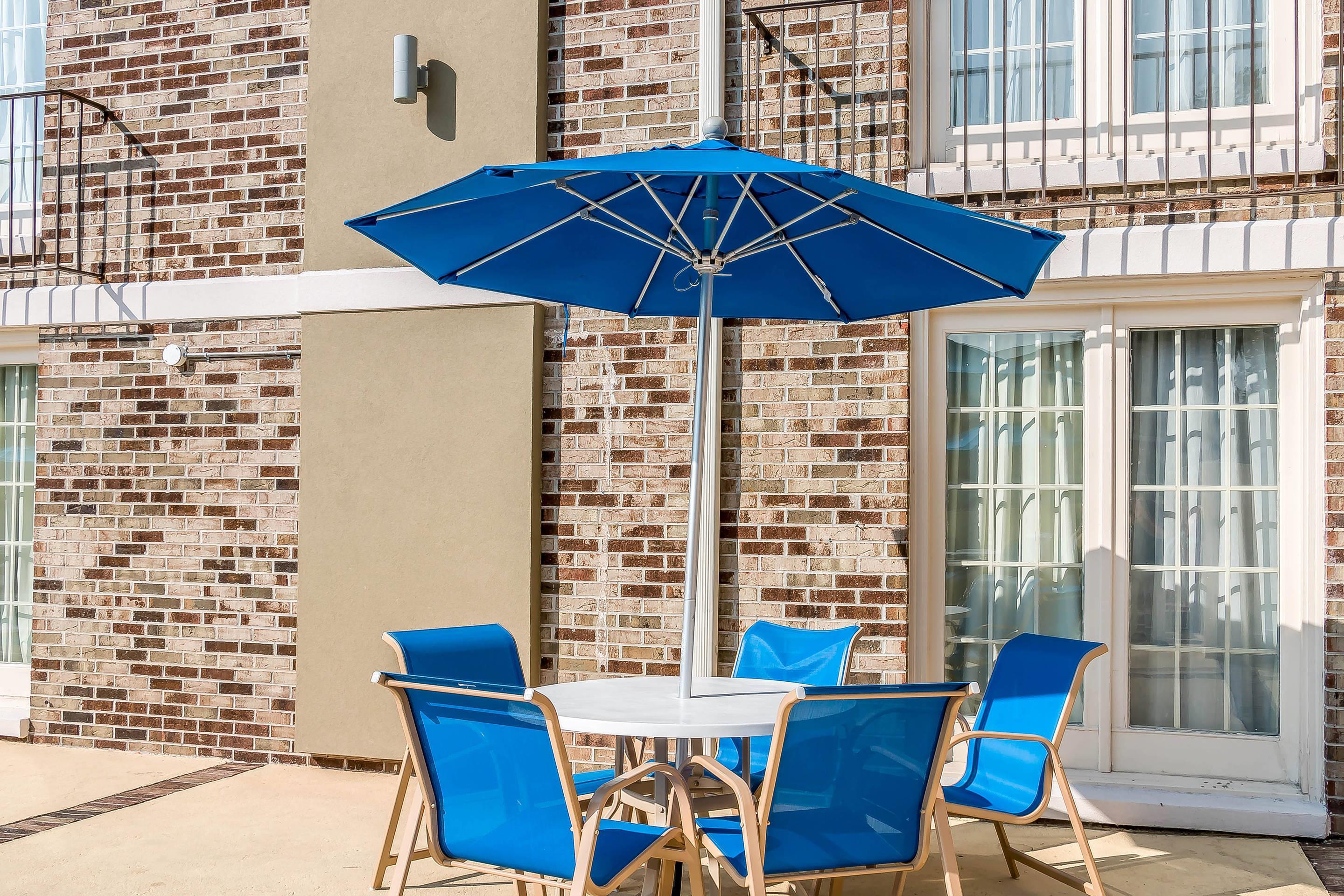 Outdoor pool with sitting area | Comfort Inn
