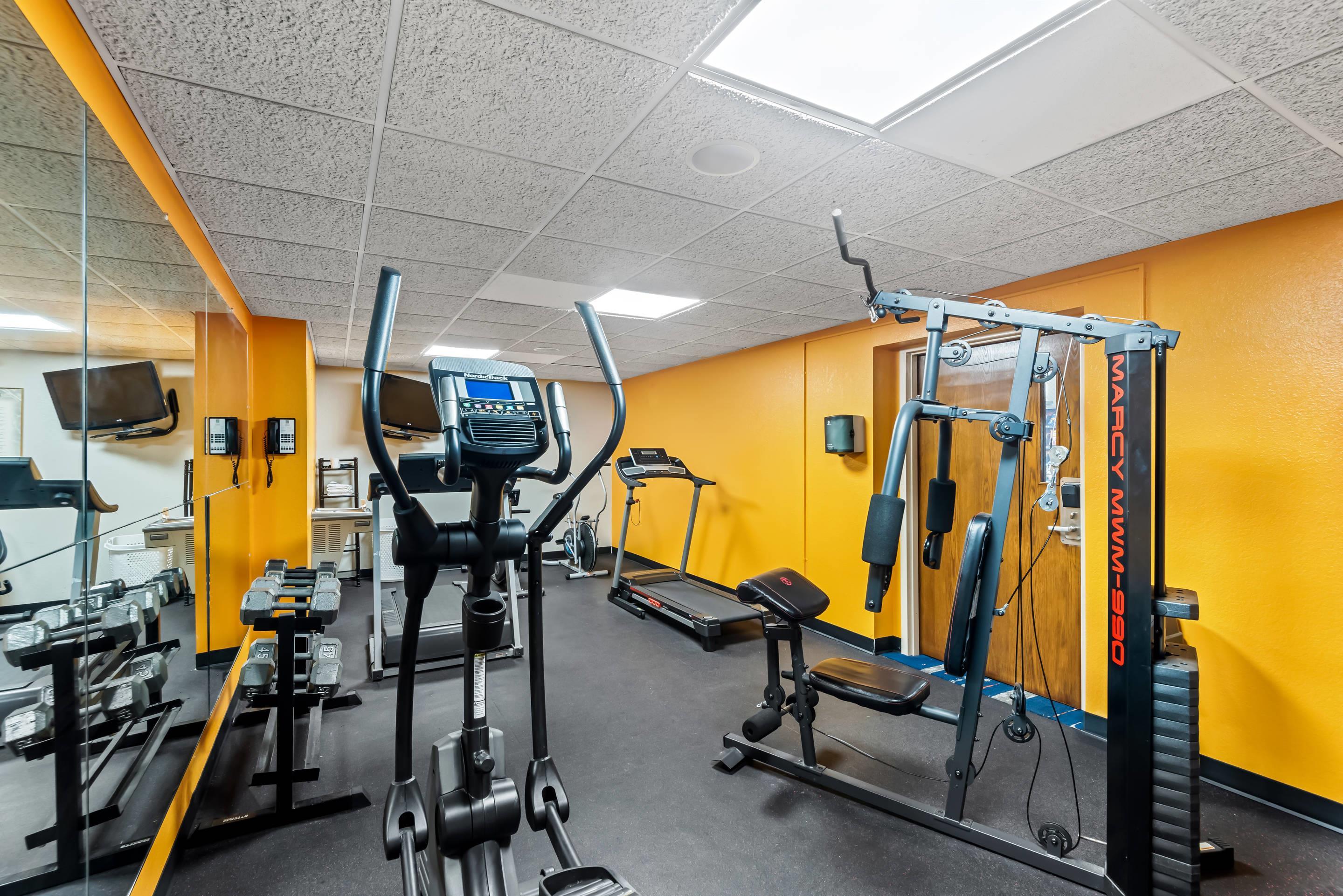 Exercise room with cardio equipment and weights