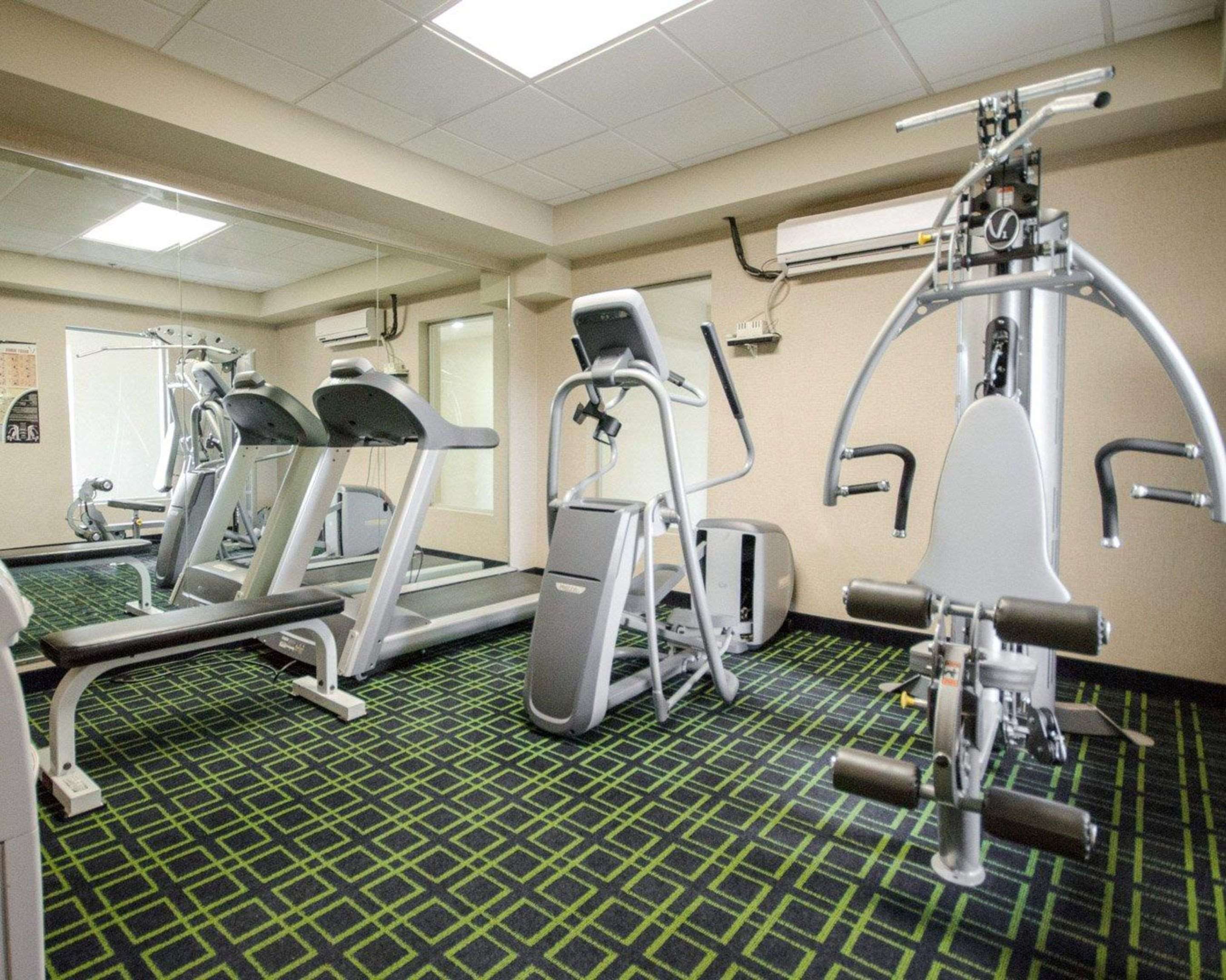 Exercise room with cardio equipment and weights | Clarion Pointe by Choice Hotels Corydon
