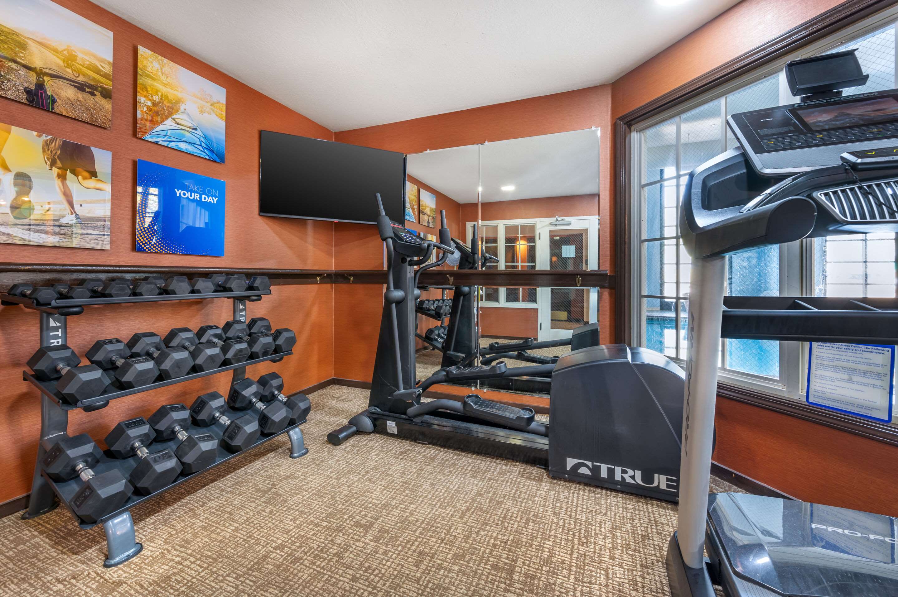 Exercise room with cardio equipment and weights