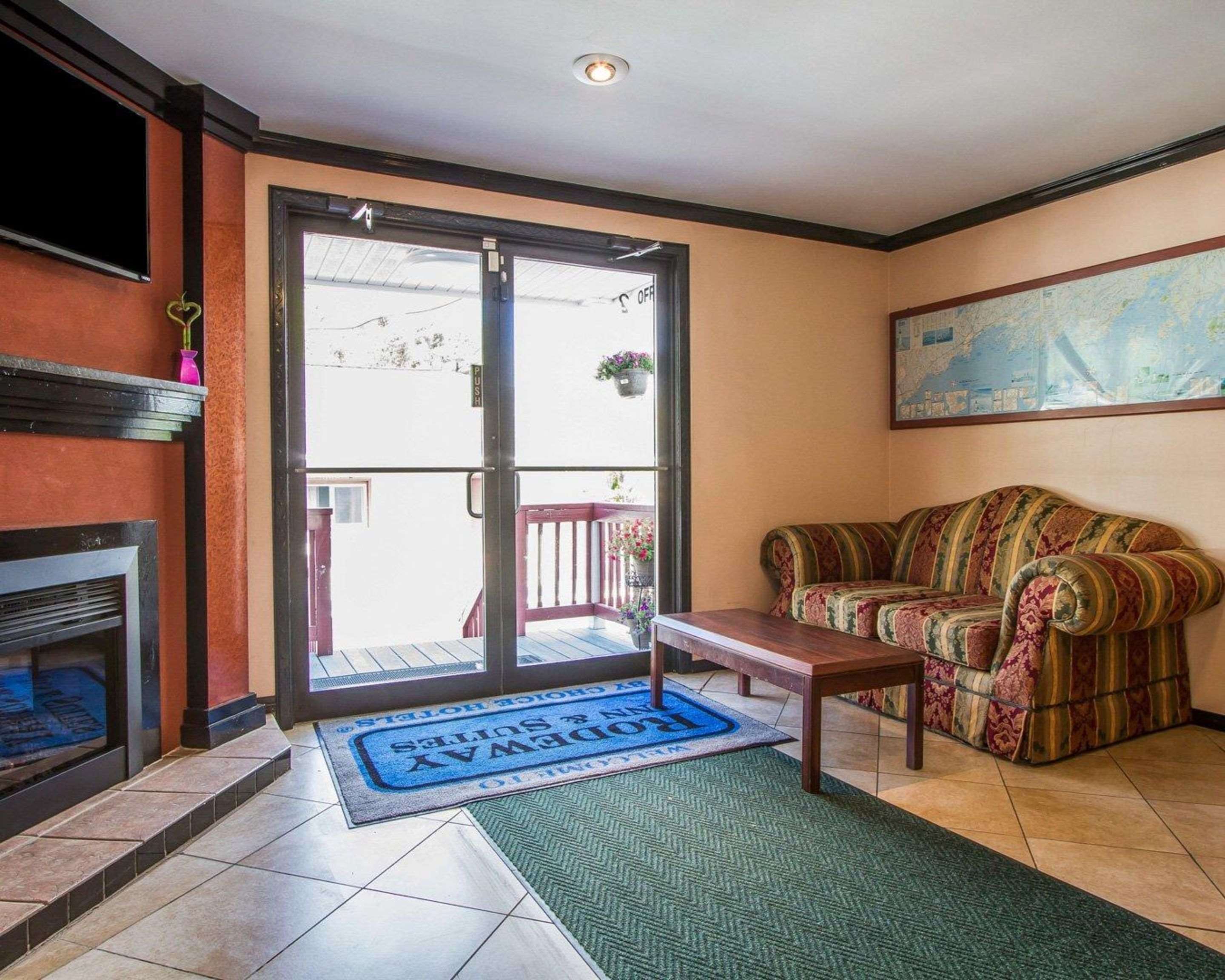 Relax by the fireplace in the lobby | Rodeway Inn & Suites Brunswick near Hwy 1