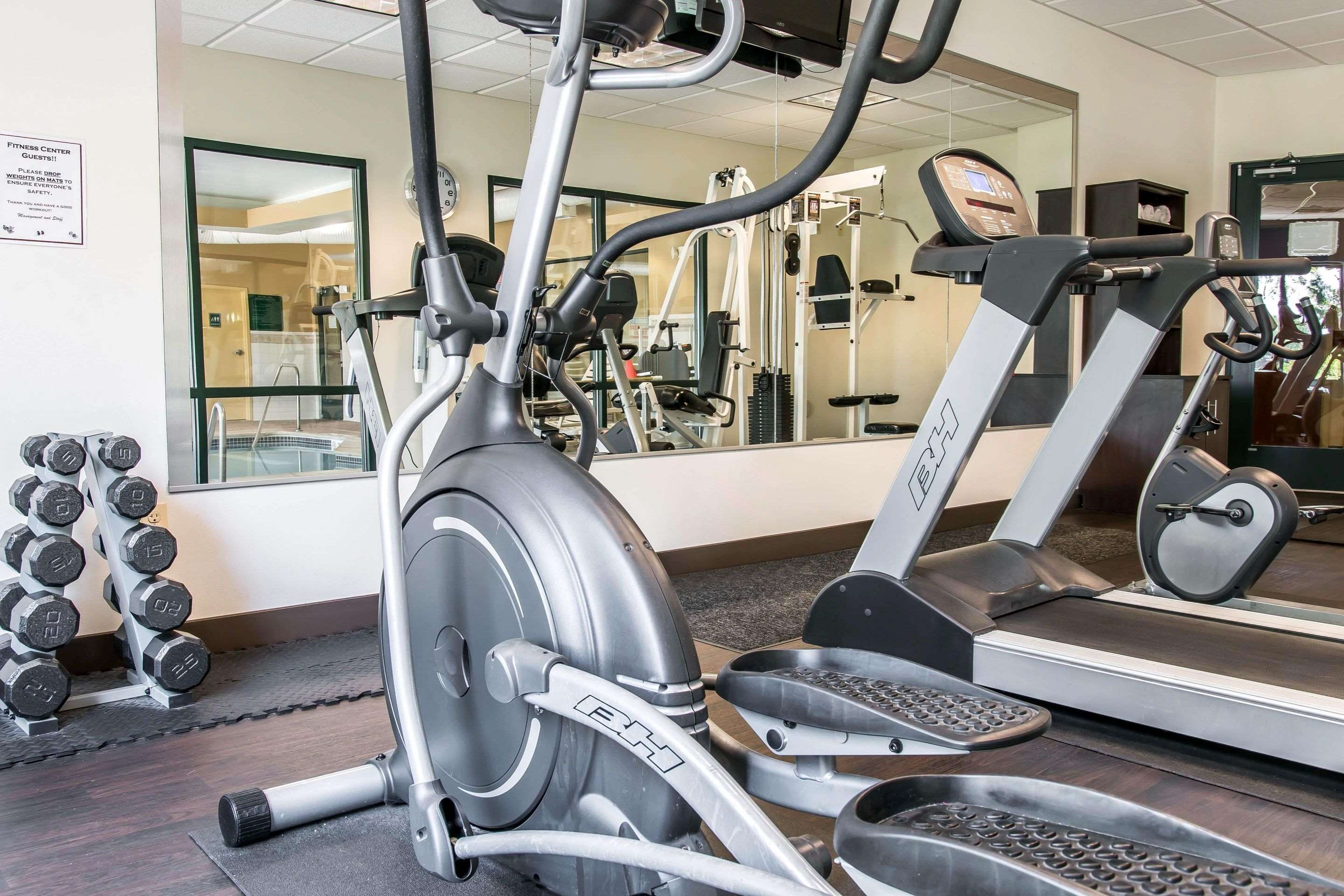 Exercise room with cardio equipment and weights | Comfort Suites Canton