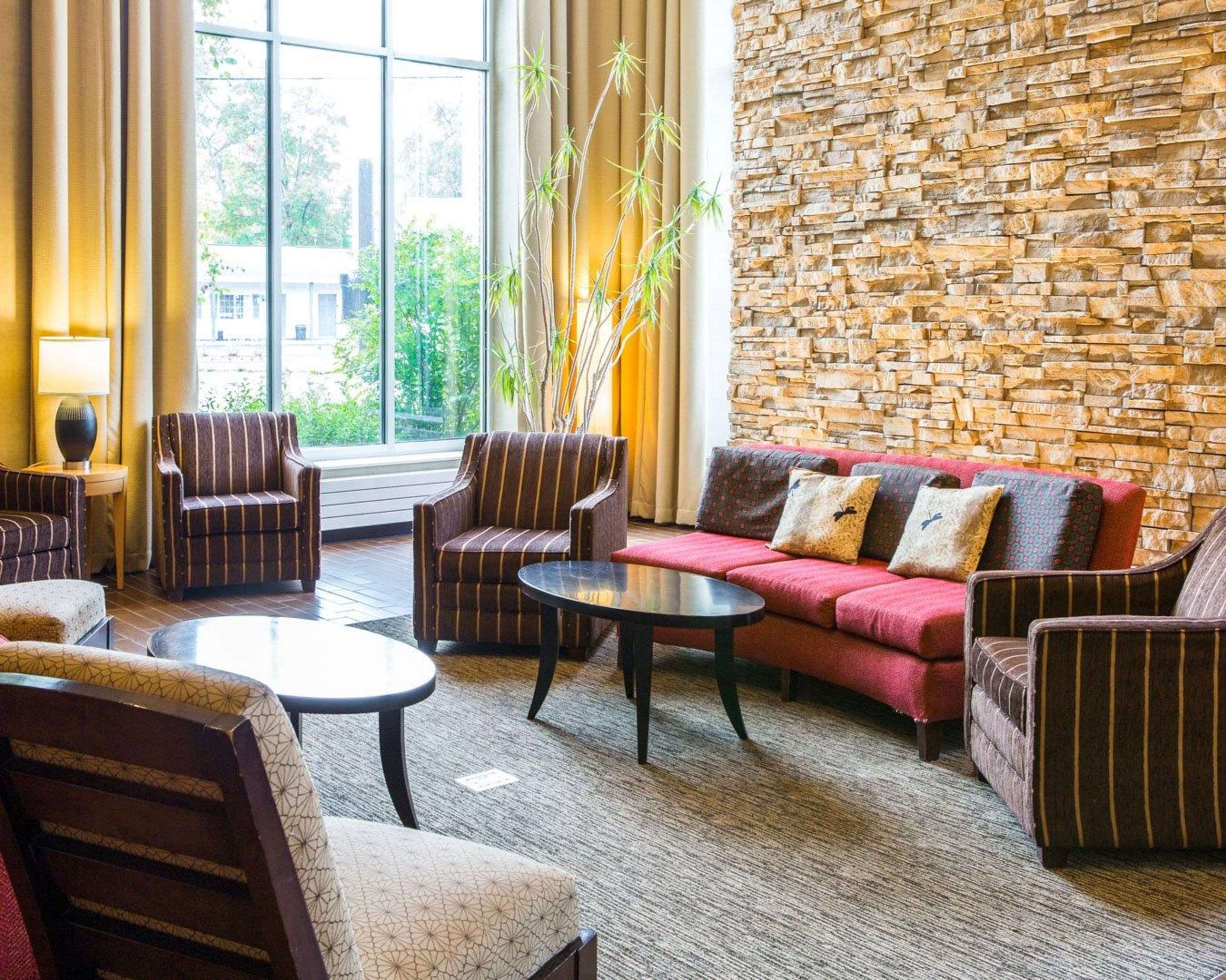 Relax in the open space lobby with club-lounge seating | Cambria Hotel Traverse City