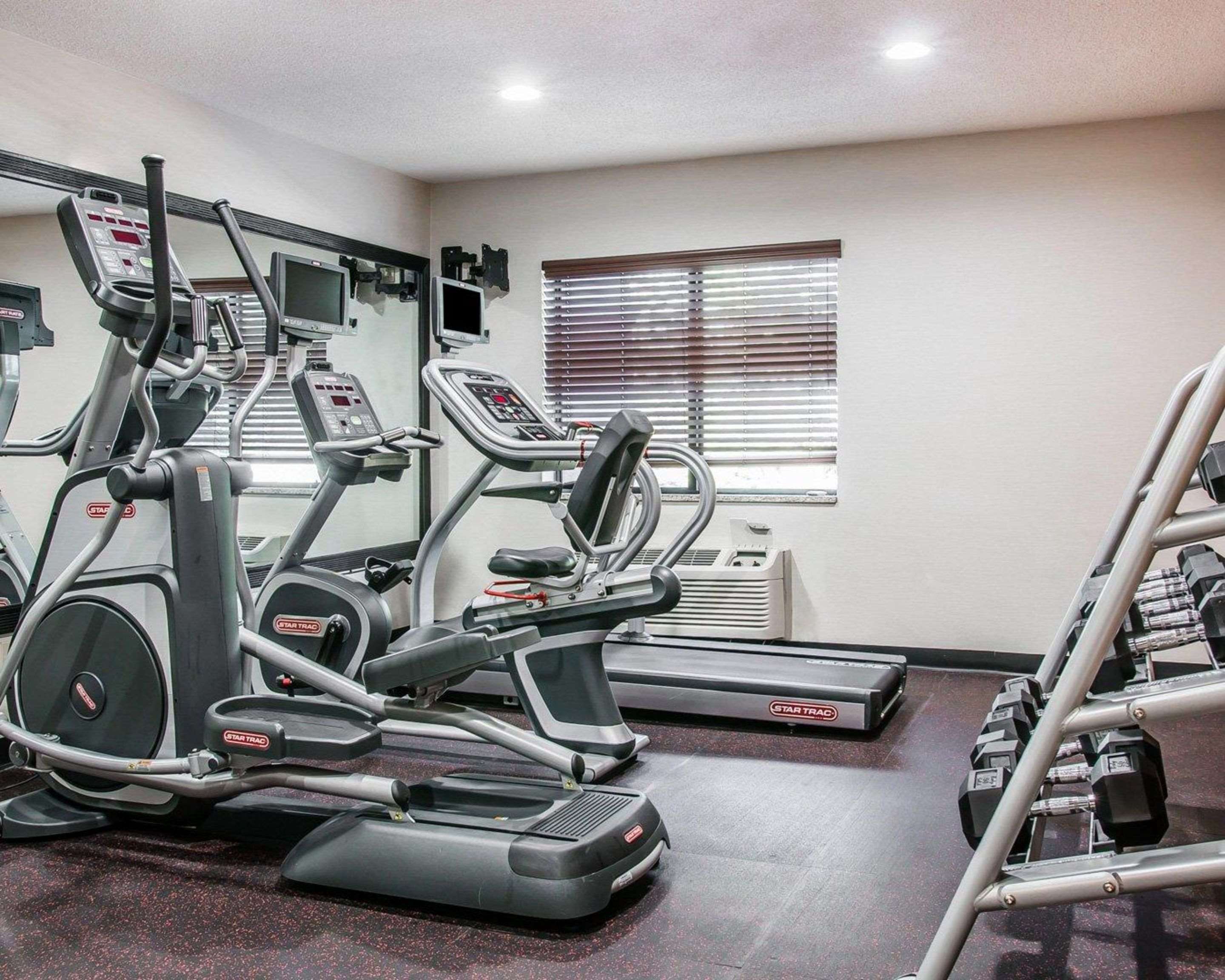 Fitness center with cardio equipment and weights | Quality Inn & Suites Warren - Detroit