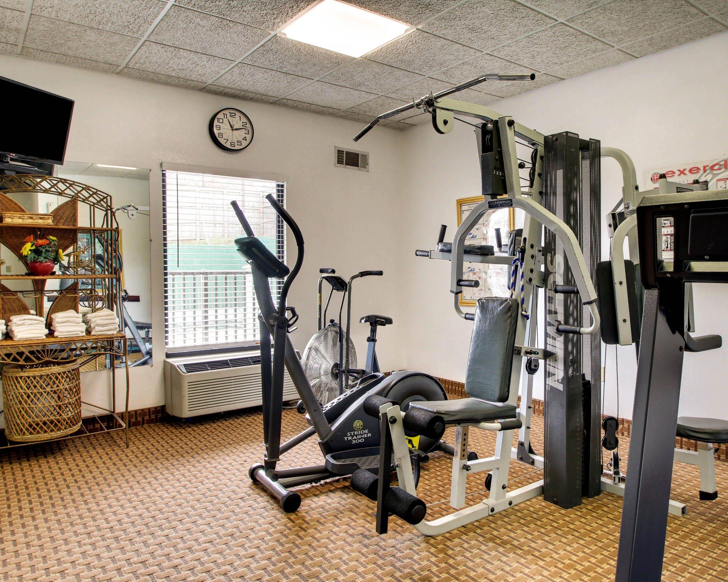 Fitness center with cardio equipment and weights | Quality Inn & Suites