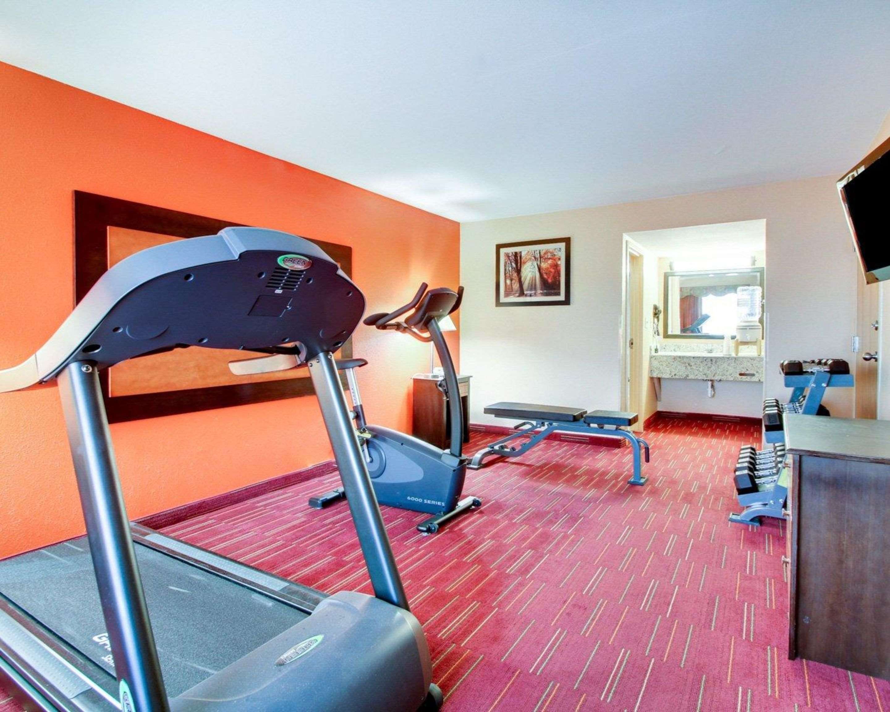 Fitness center with cardio equipment and weights | Quality Inn