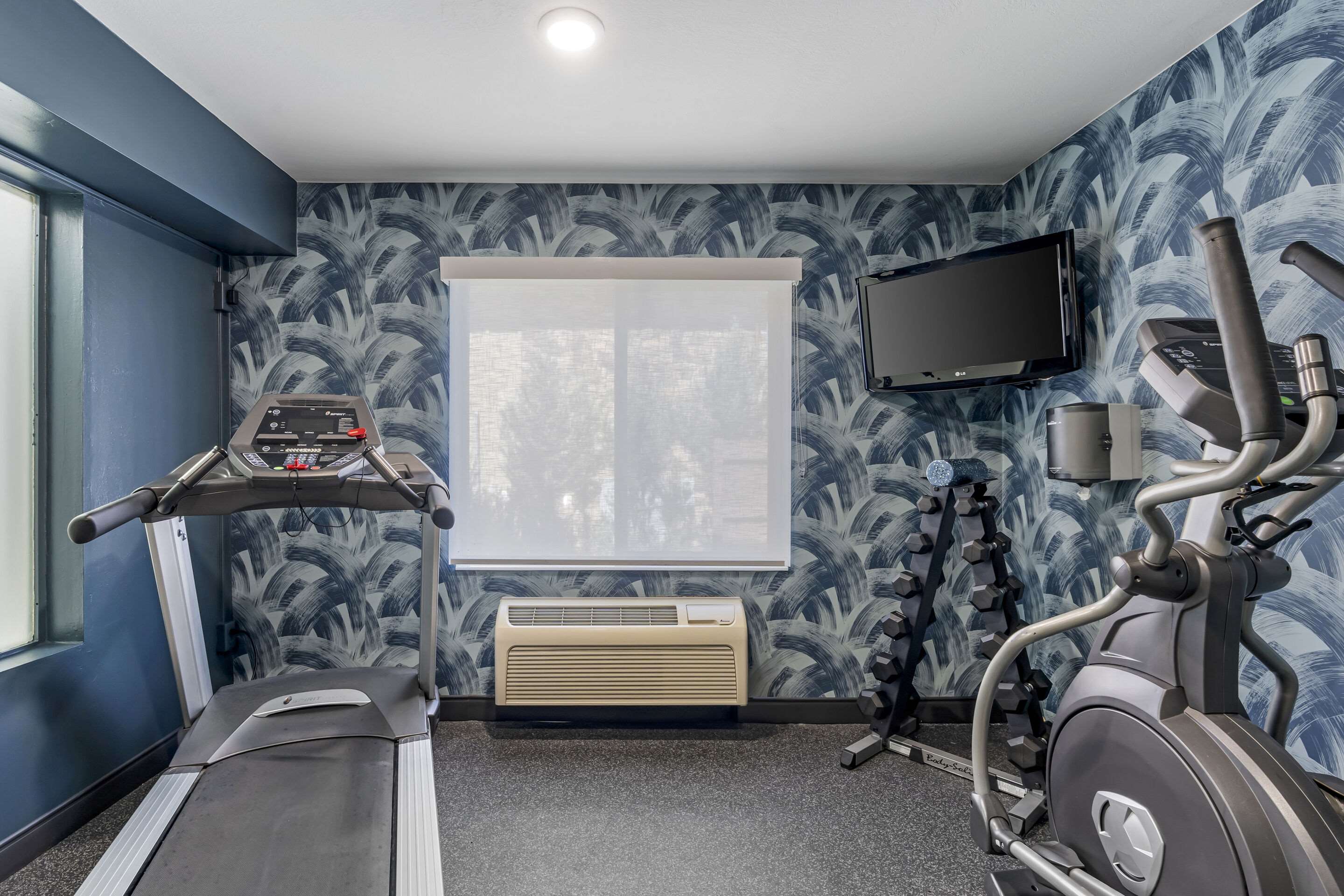 Exercise room with cardio equipment | Quality Inn