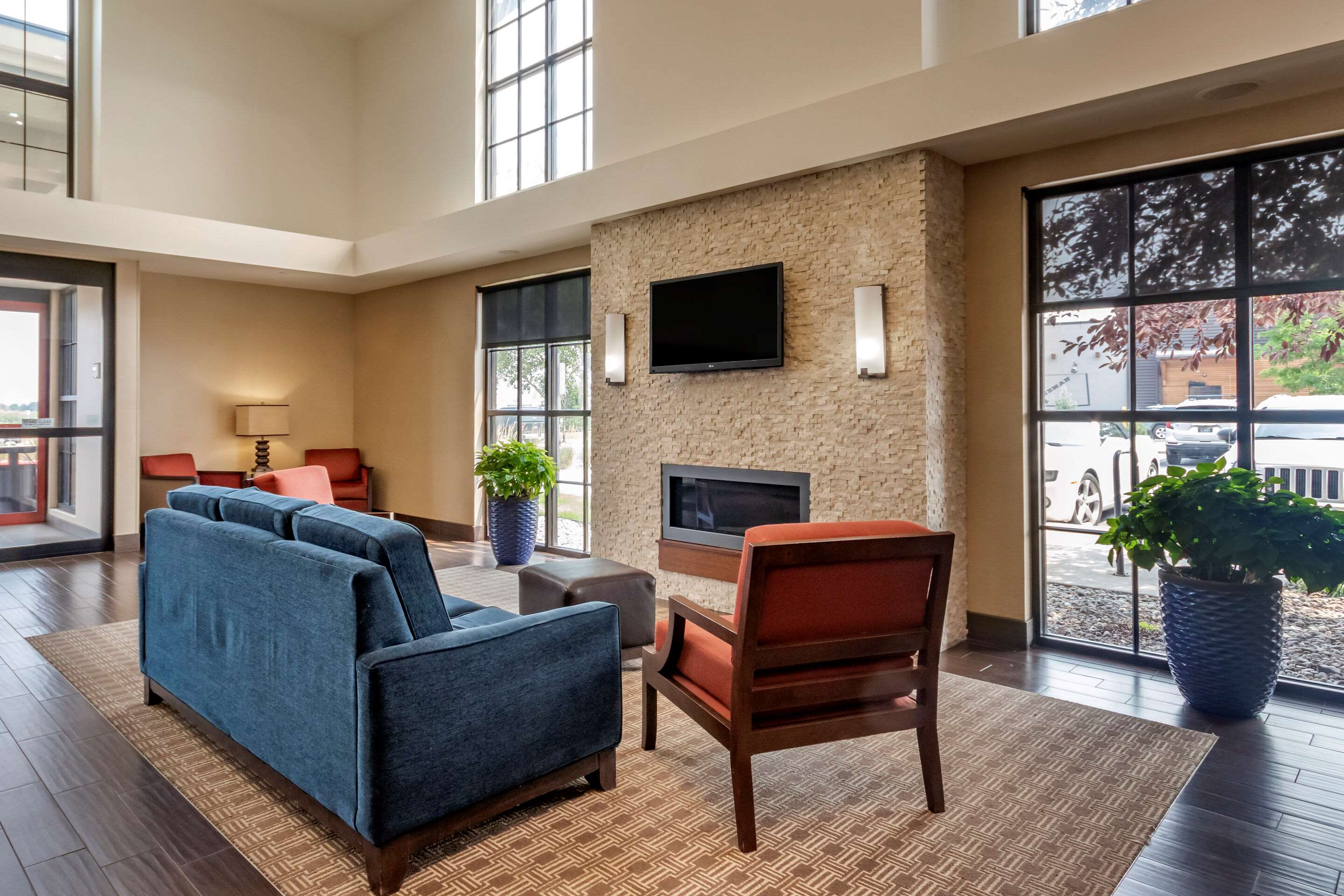 Spacious lobby with sitting area | Comfort Suites Airport - University