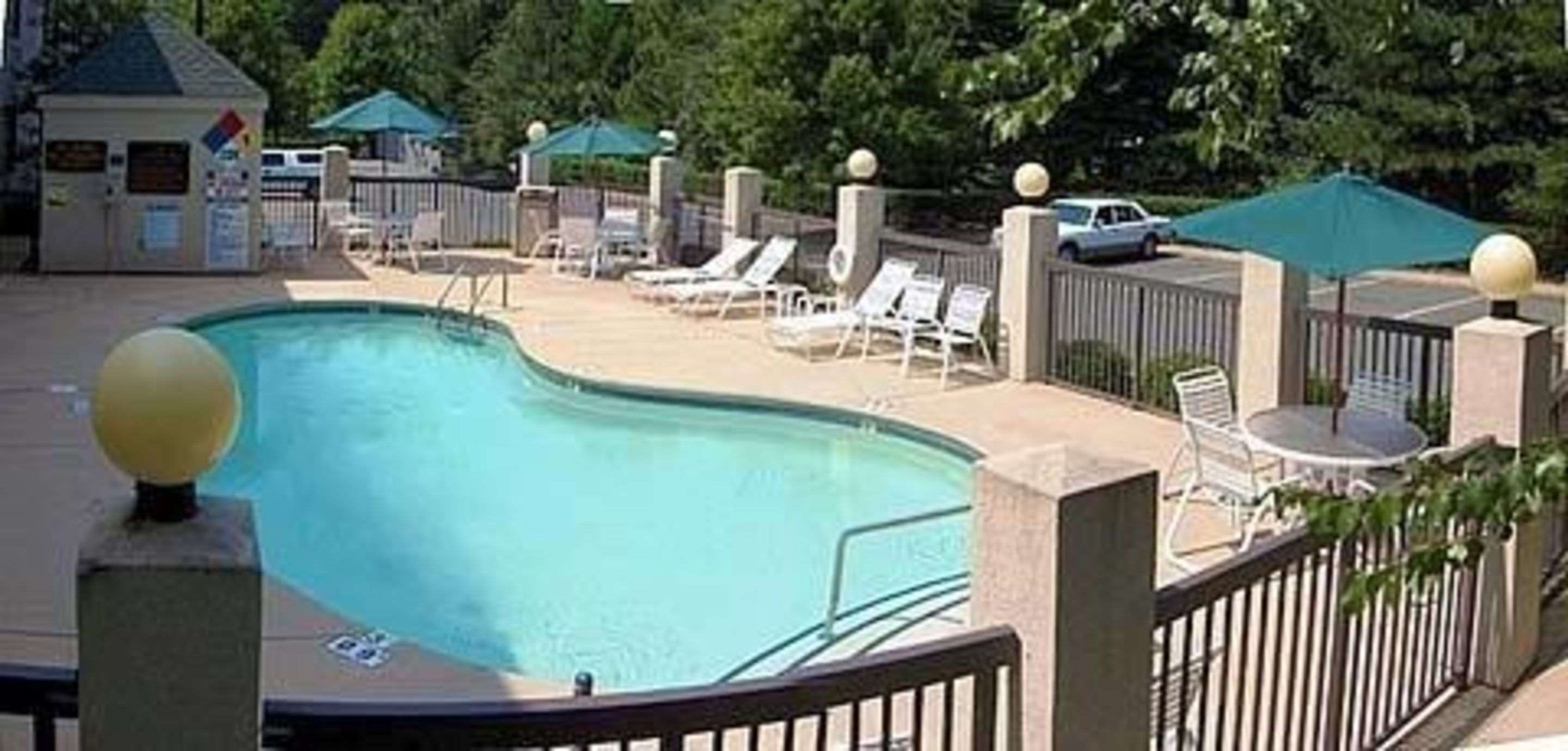 Outdoor pool with sundeck | Sleep Inn Airport - Billy Graham Parkway