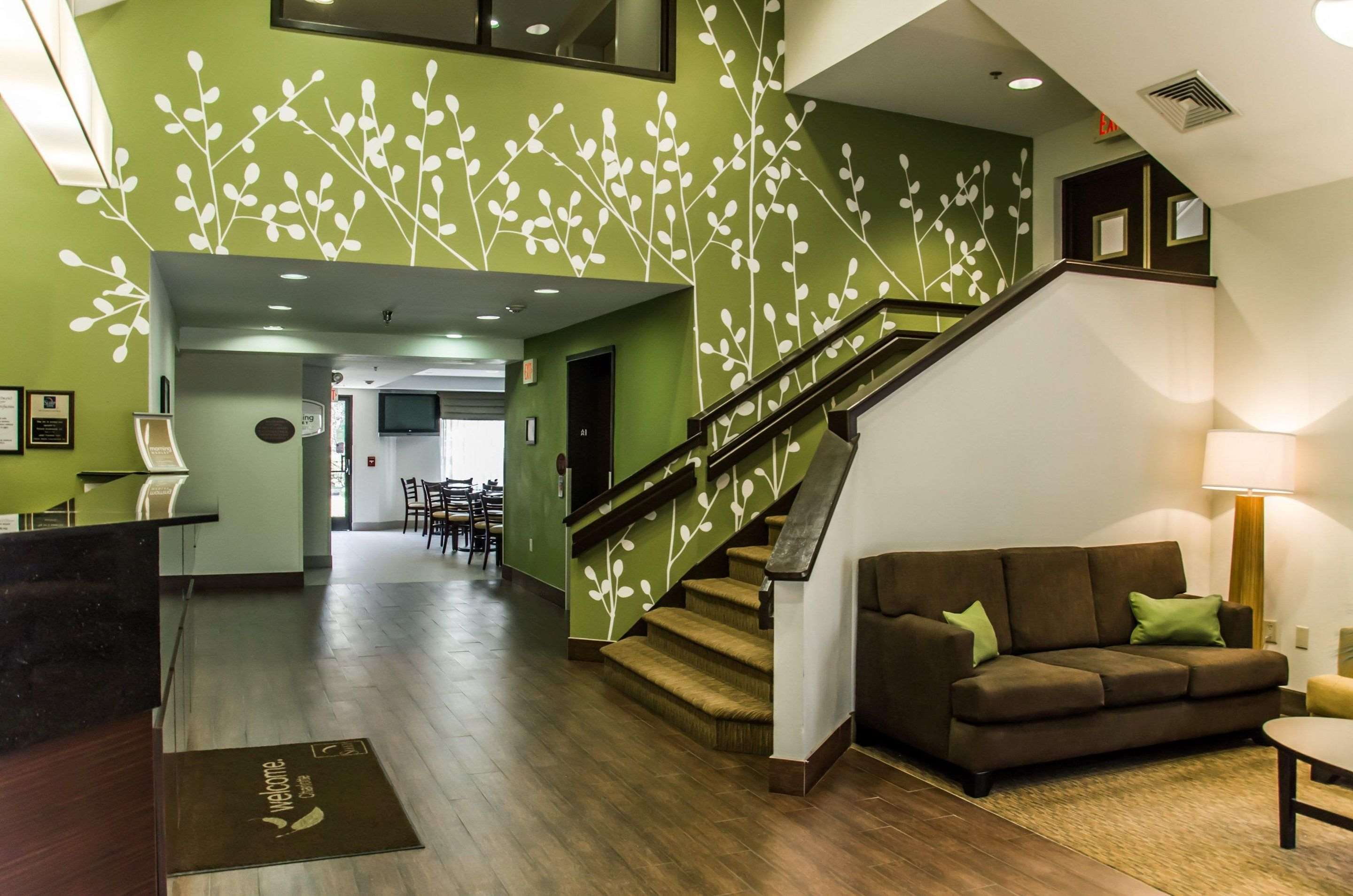 Spacious lobby with sitting area | Sleep Inn Airport - Billy Graham Parkway