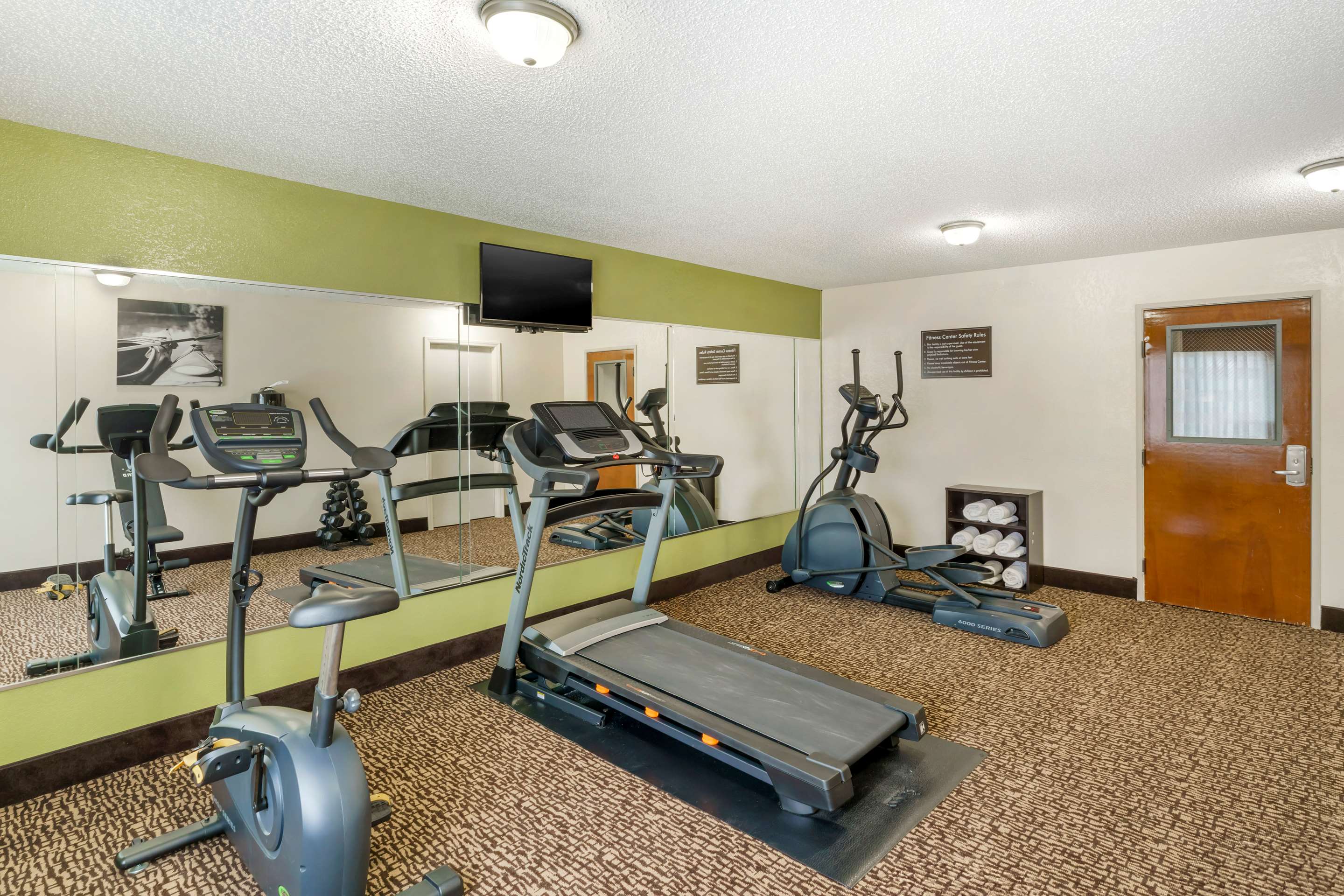 Exercise room with cardio equipment | Sleep Inn
